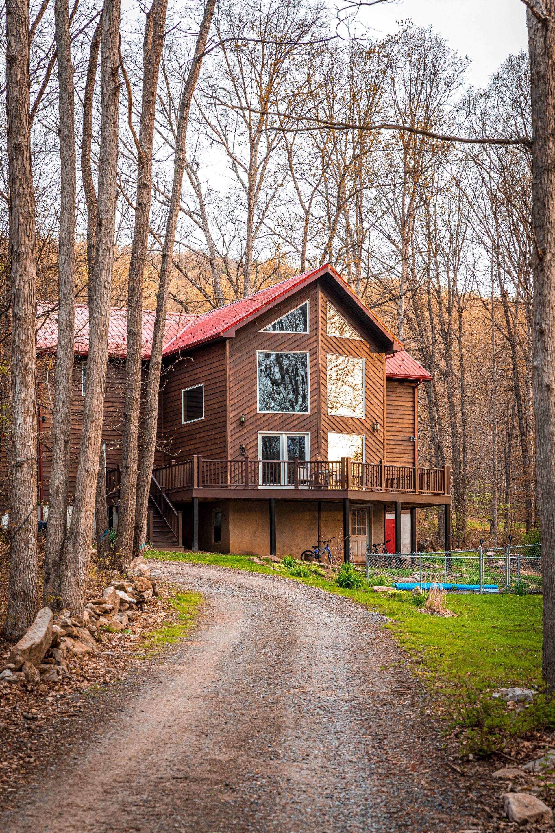Metal Roof-barn red and new deck by Esh Builders