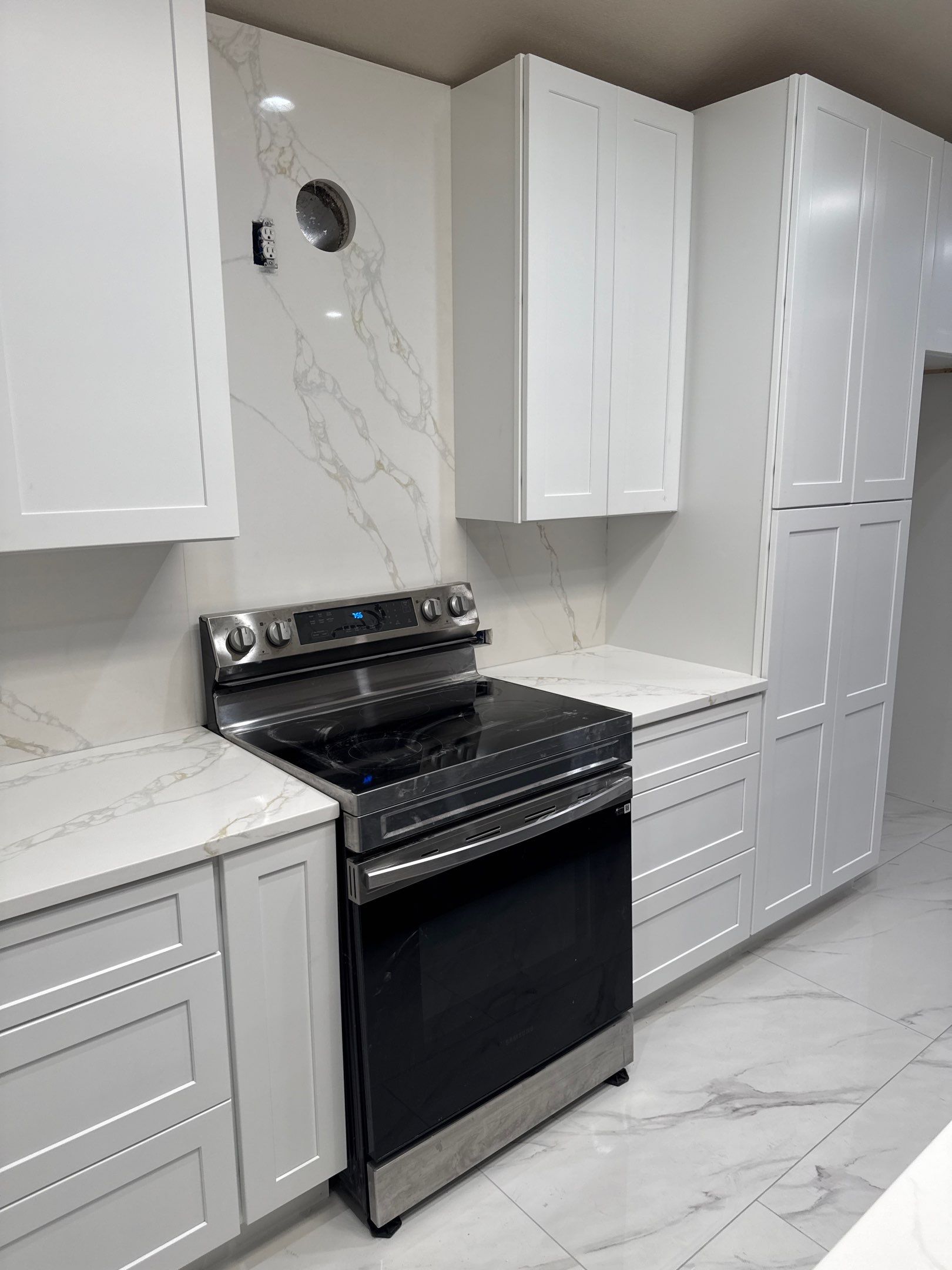 Luxury Focal Point: Full Kitchen Remodel with Double Waterfall Island by Tibi Soli LLC