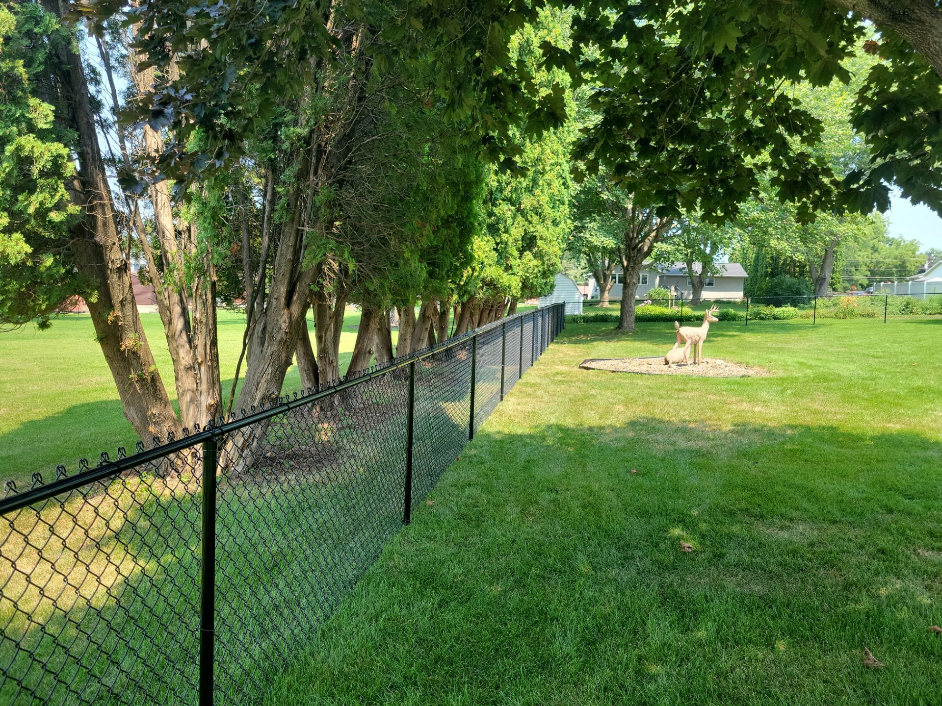 Black Vinyl-Coated Chain Link Fence Installation in New Hampton by Perfect Picket Fence and Stain