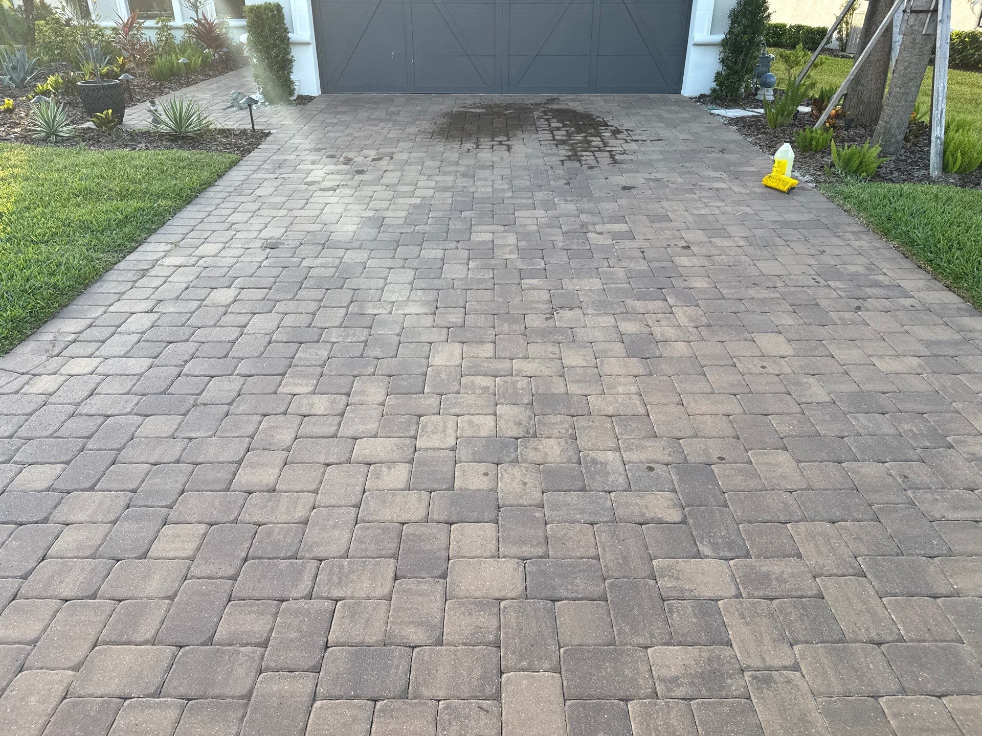 Oil Stain Removal on Paver Driveway | Esplanade at Artisan Lakes, Palmetto FL by Sunshine AquaWash