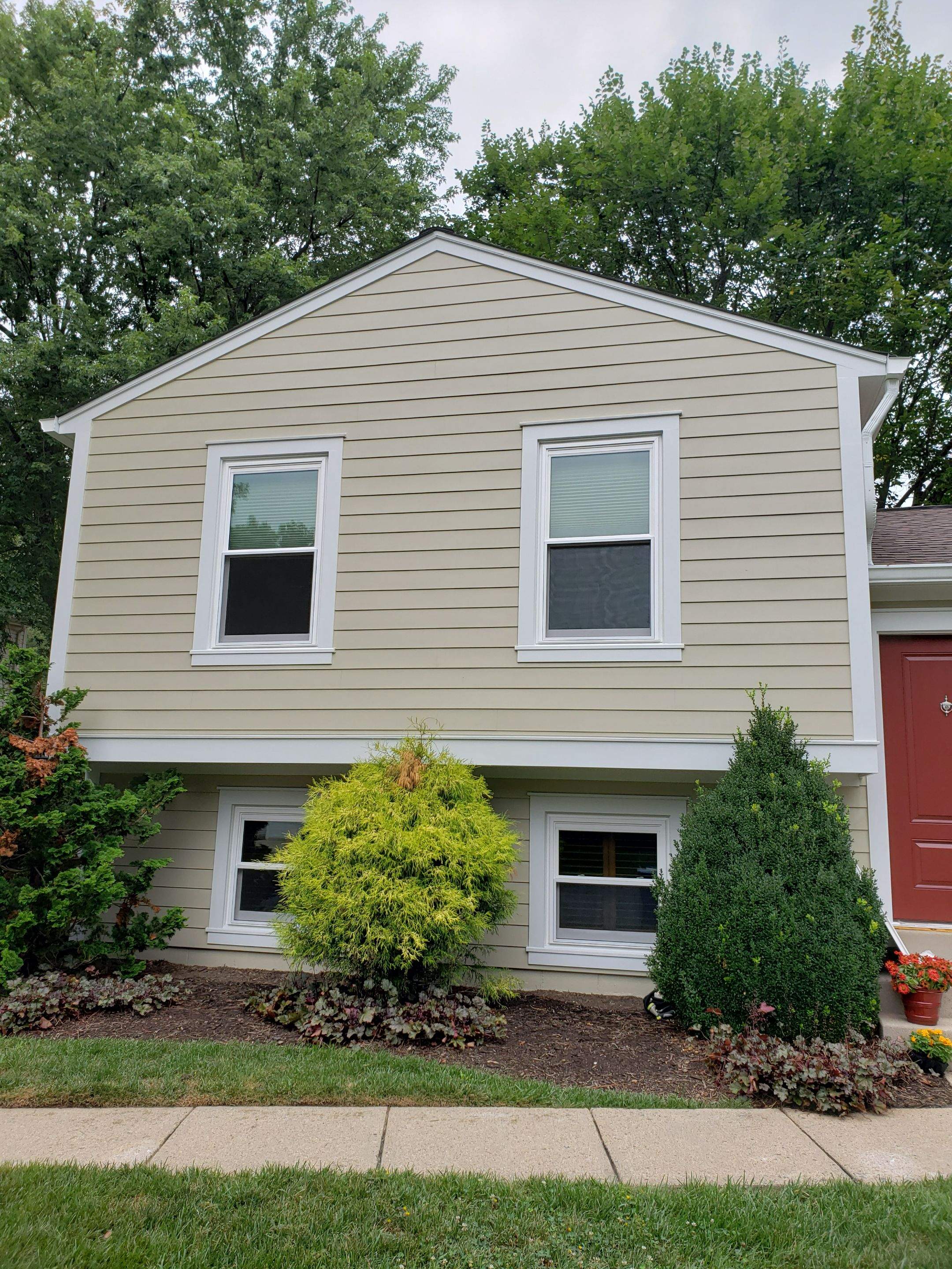 New composite windows and fiber cement siding with trim and gutters by Window Depot of Annapolis