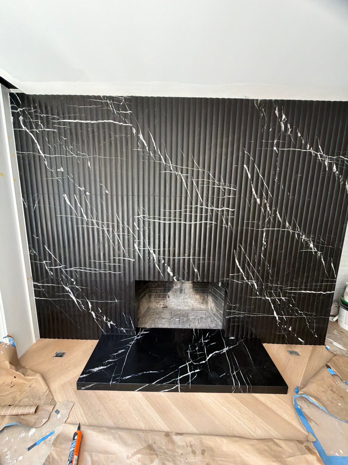 Full-Height Fluted Marble Fireplace Wall by NC Stone And Tiles