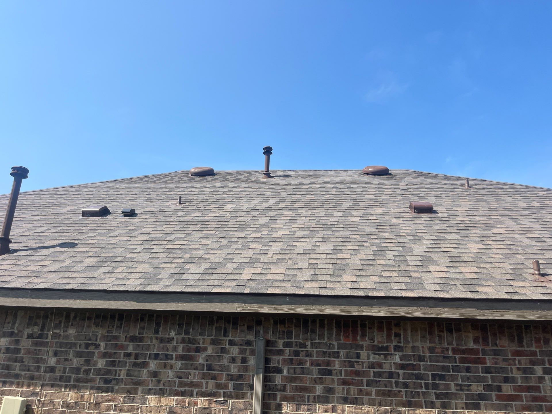 Medium brown brick with IKO Driftshake by Tejas Roofworks + Restoration