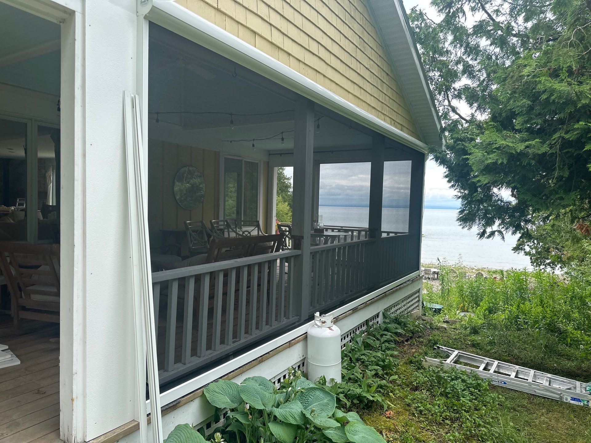 Sunesta motorized Sentry Privacy Screen Installation for Saint Ignace Waterfront Porch by Rainbow Seamless Systems