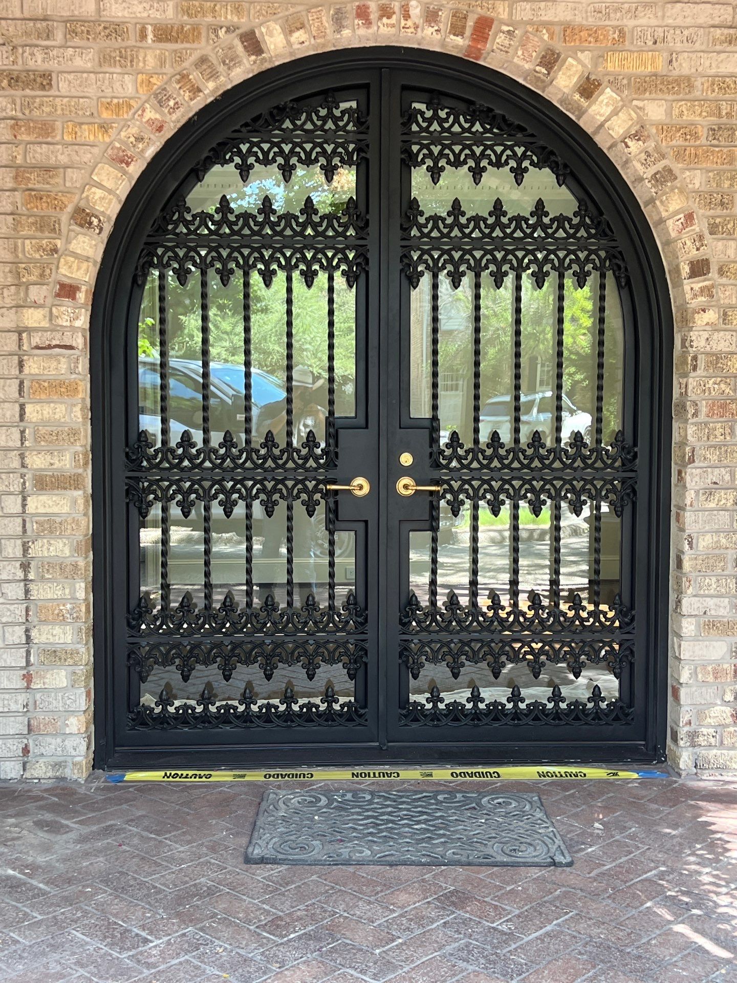 Custom Arched Black Wrought Iron Double Door Installation in Dallas by Solara Custom Living