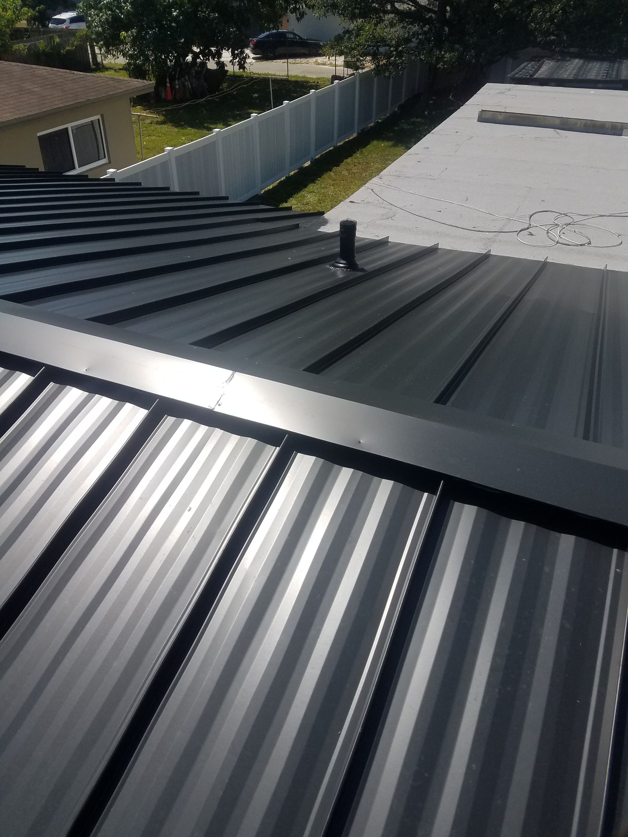 Standing Seam Metal & Flat Re-Roof using 1.5" Nail Strip 24ga Black Matte Kynar Coated Standing Seam Metal Panels by Morton Roofing, Inc.