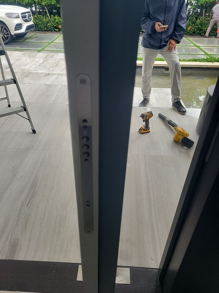 Custom Material Pivot Door installation by Impact Precious Wood Inc.