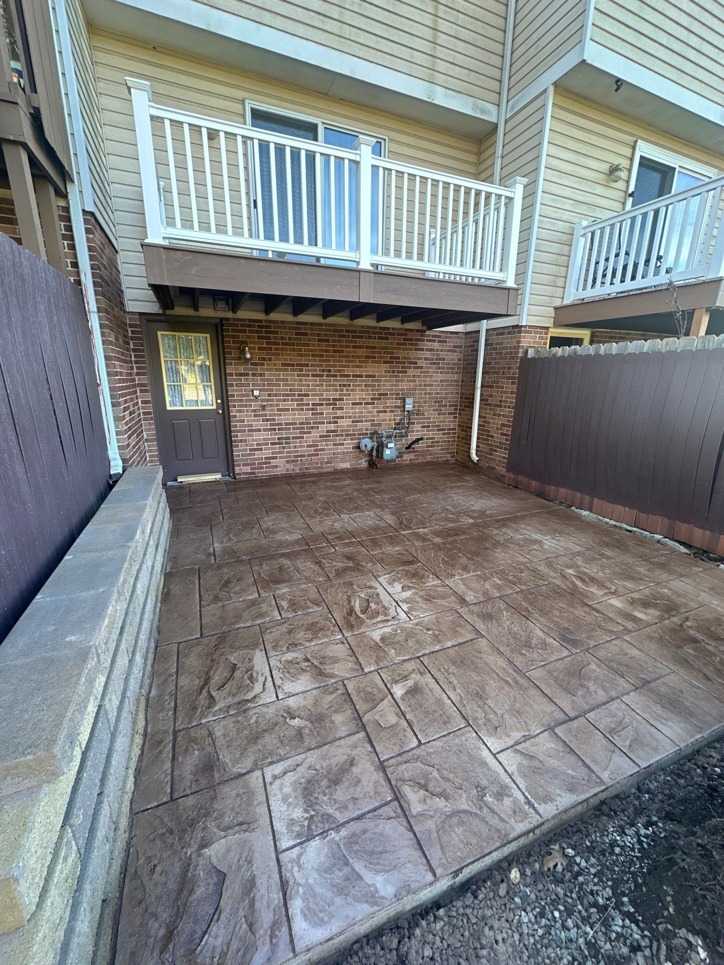 Stamped concrete and redeck  by Cousins Roofing Siding & Decks