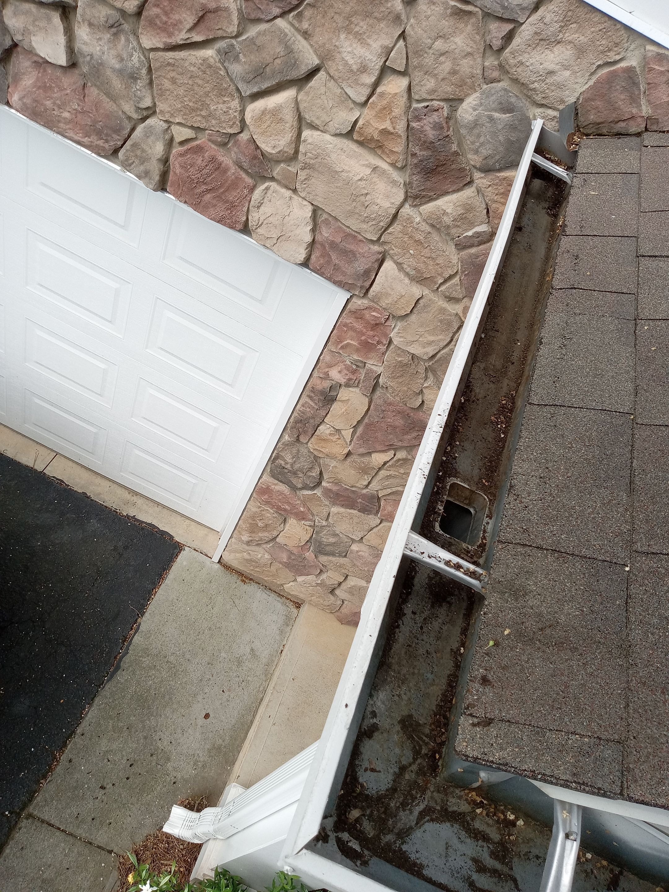 HOA gutter cleaning in Cumming & Forsyth County, GA, after  photo showing full gutters.