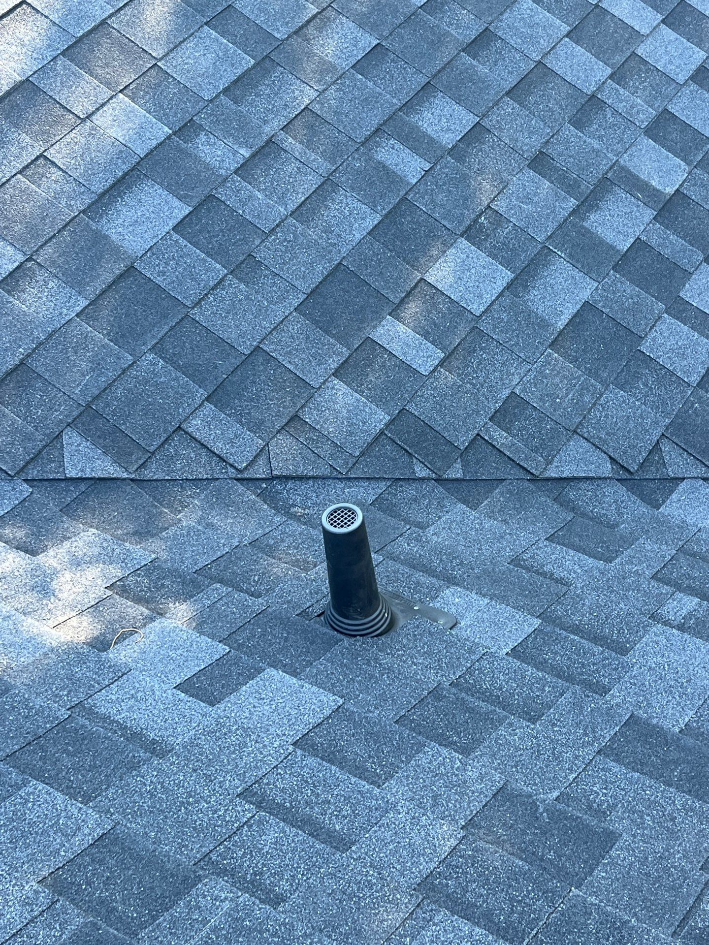 White brick with IKO Granite Black by Tejas Roofworks + Restoration