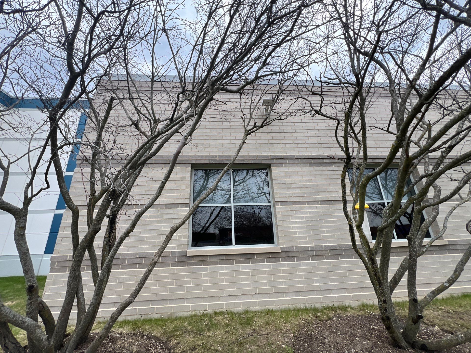 Commercial Facade cleaning using Algaecide, soft wash soap by Northern Power Washing LLC.