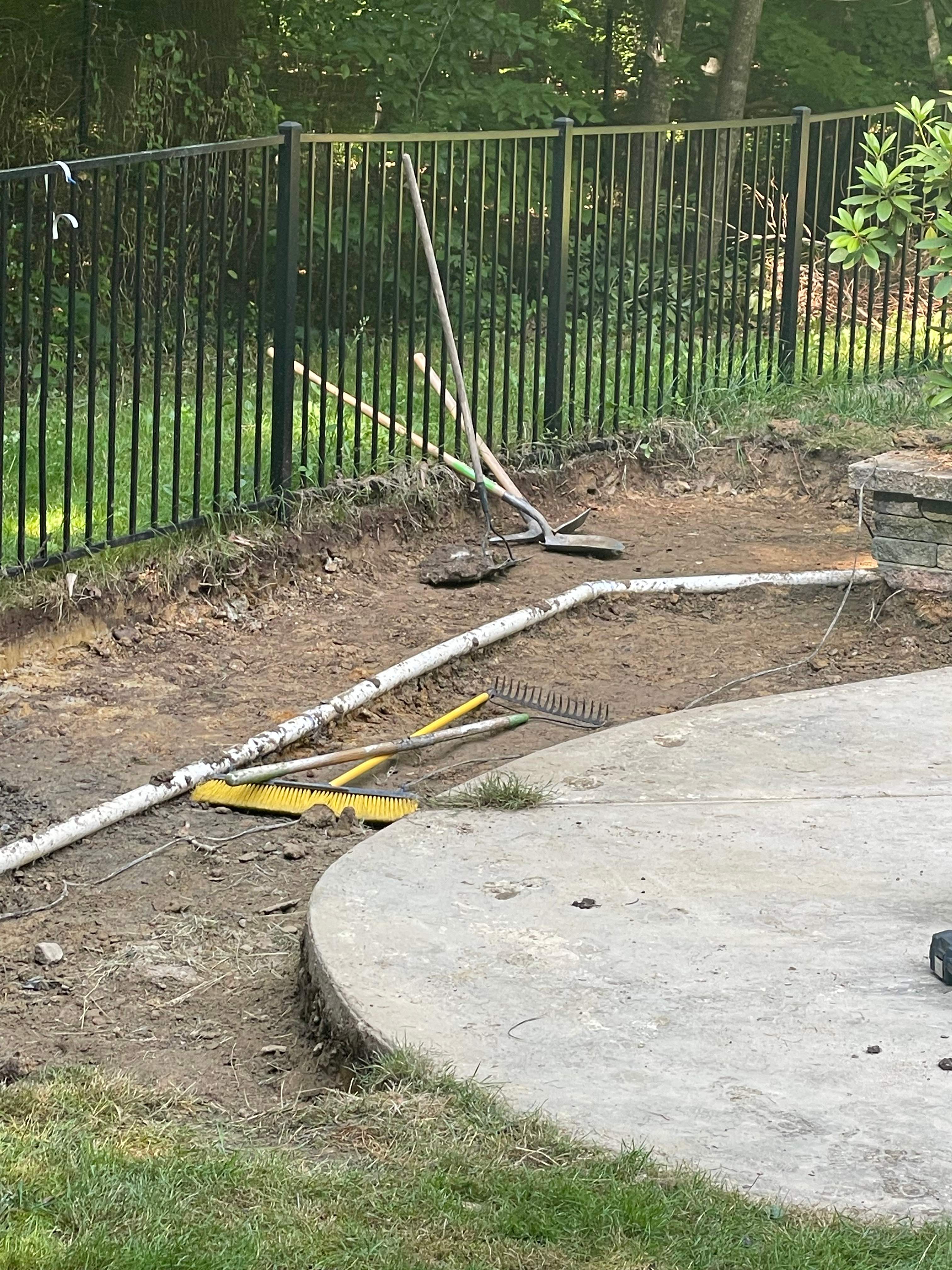Pool Surround remodel with retaining walls, new waterfall and water slide by Fairfax Contractors, LLC
