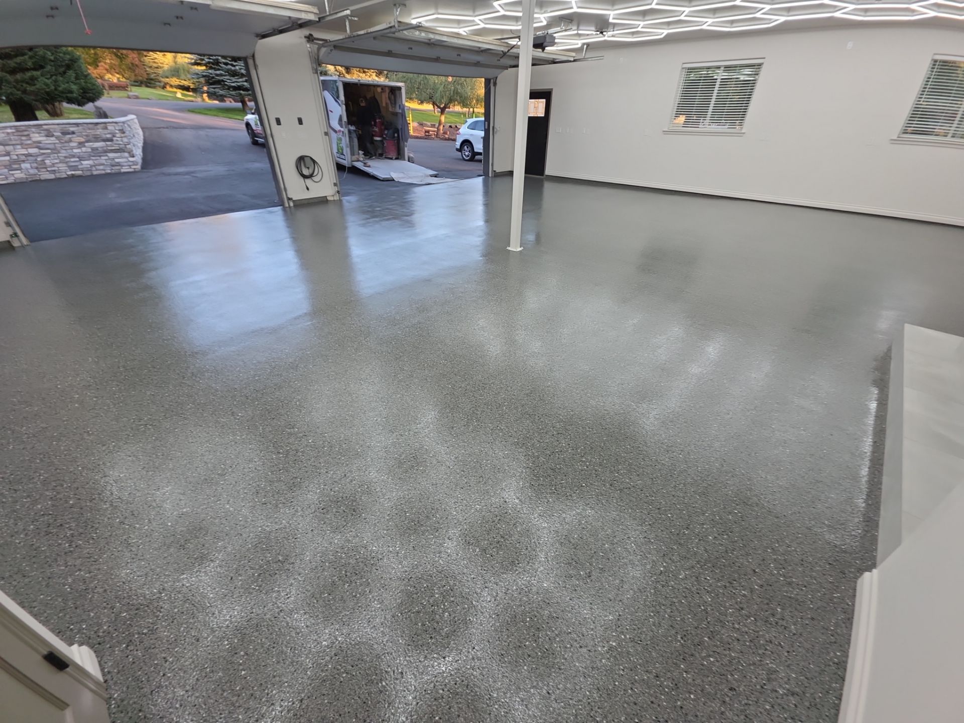 Custom Garage Transformation with Polyaspartic Coating and Hexagonal LED Lighting by Croc Coatings, LLC
