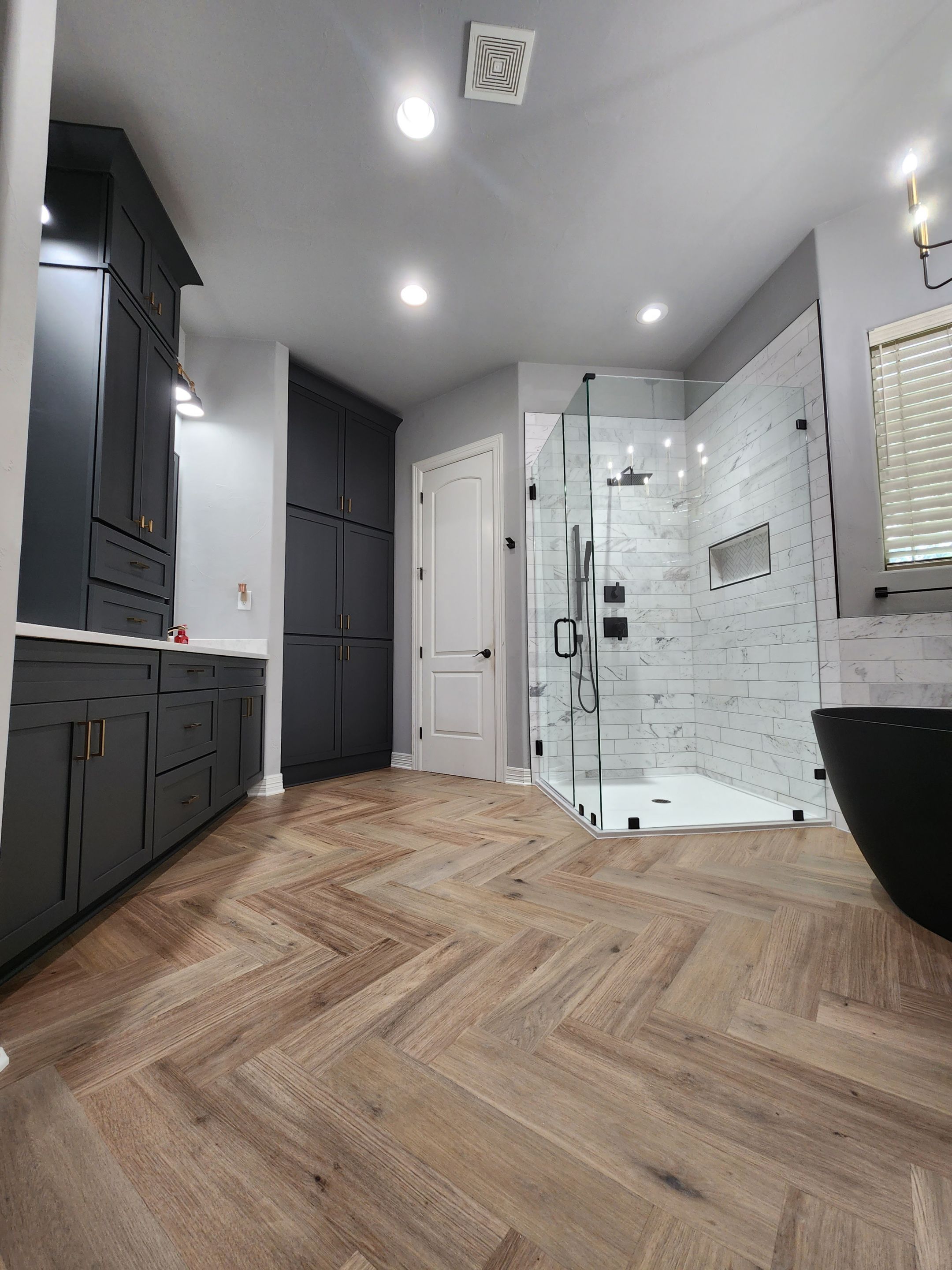 Spring Bathroom Remodel with Black Free-Standing Tub and Walk-In Shower by Legacy Bath and Kitchen