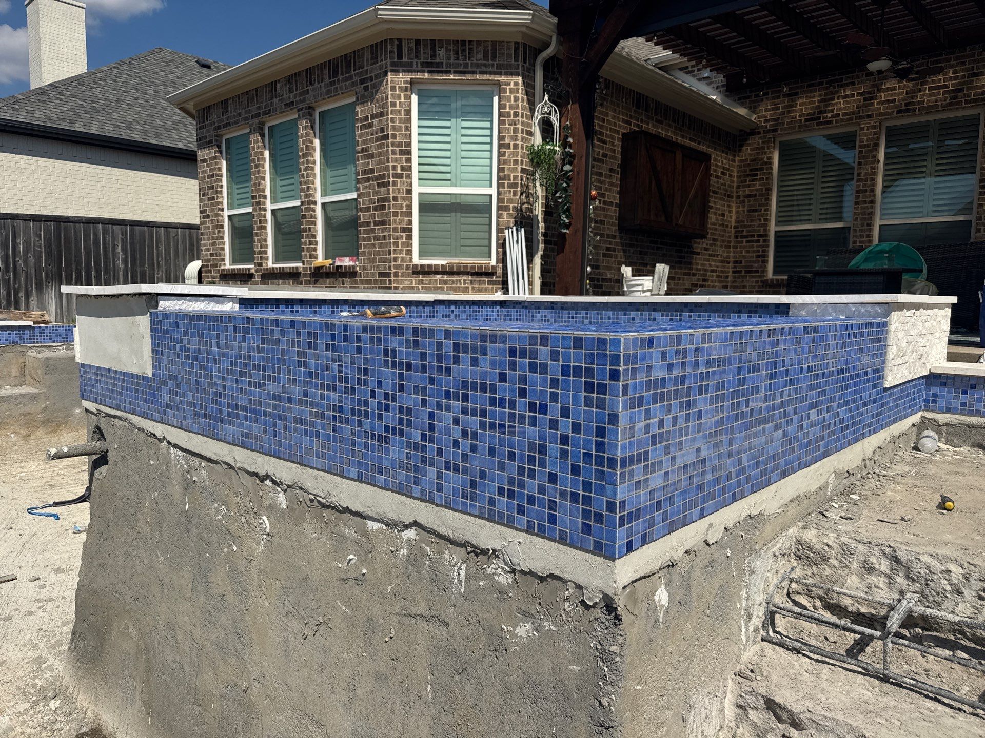 Geometric Pool with Raised Spa and Tanning Ledge by Pinnacle Pools and Spas - DFW
