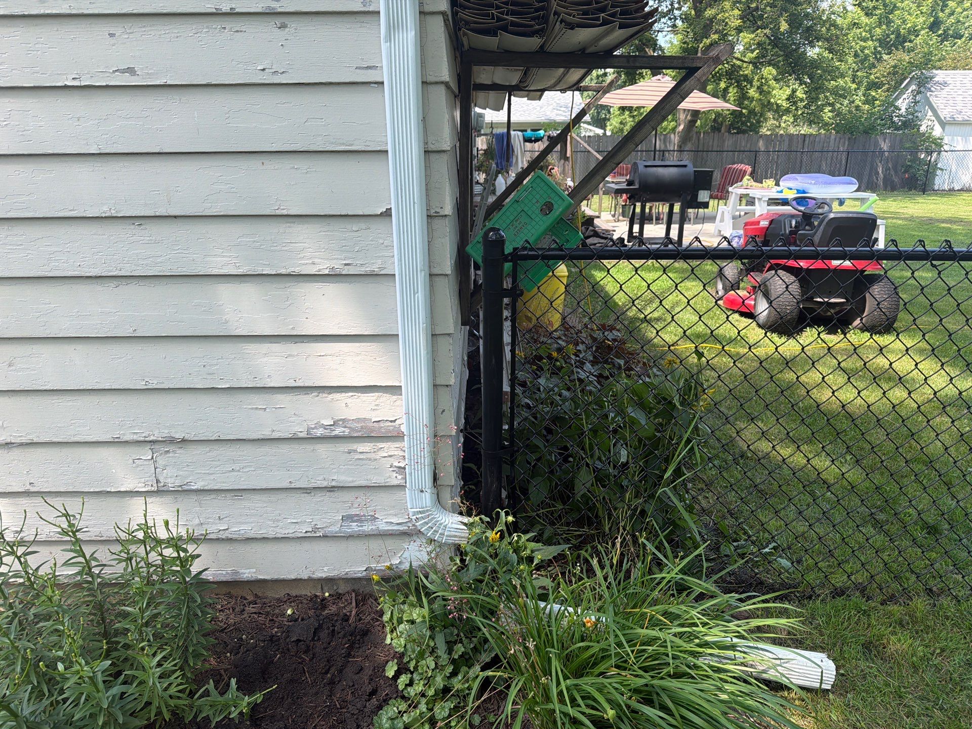 Black Chain Link Backyard Fence Installation in Tripoli, IA by Perfect Picket Fence and Stain