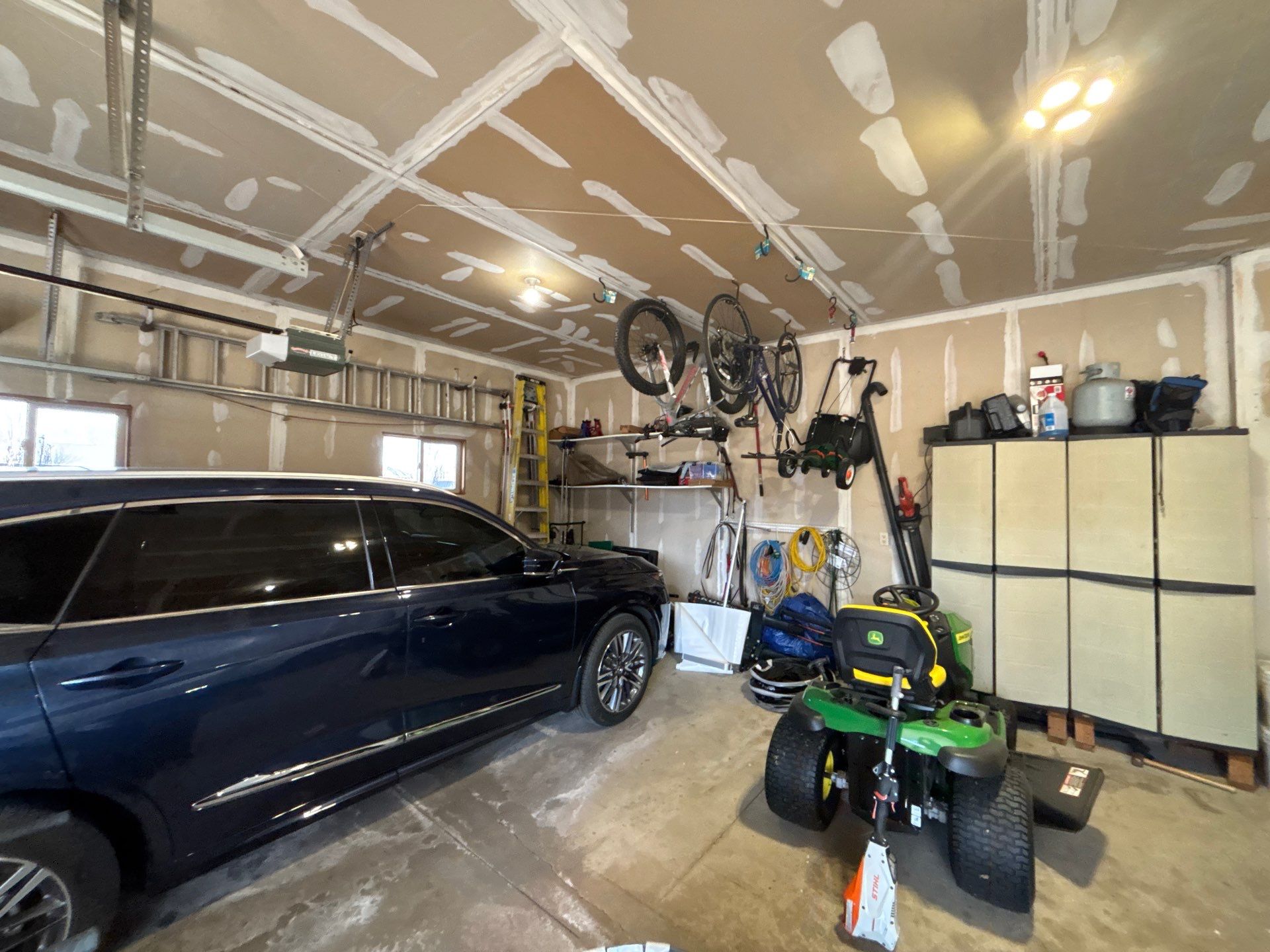 Sioux Falls Garage Concrete Repair and Epoxy Flake Floor Coating by Select Painting, Coatings & Garage Cabinets
