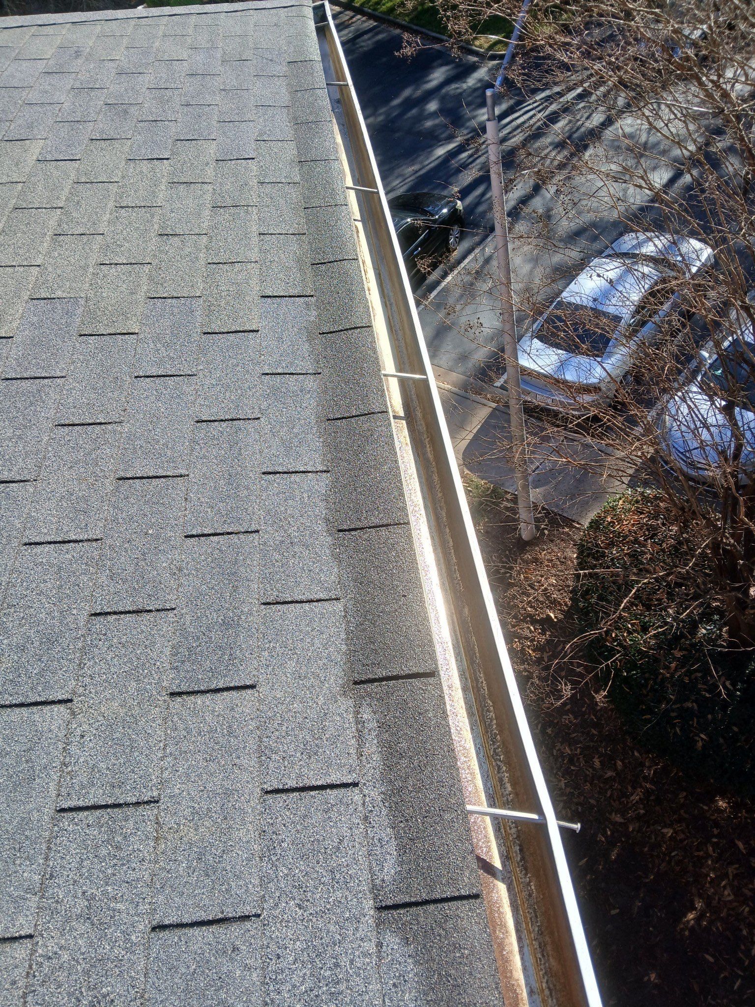 HOA gutter cleaning in Fuquay-Varina & Holly Springs, NC, after  photo showing full gutters.