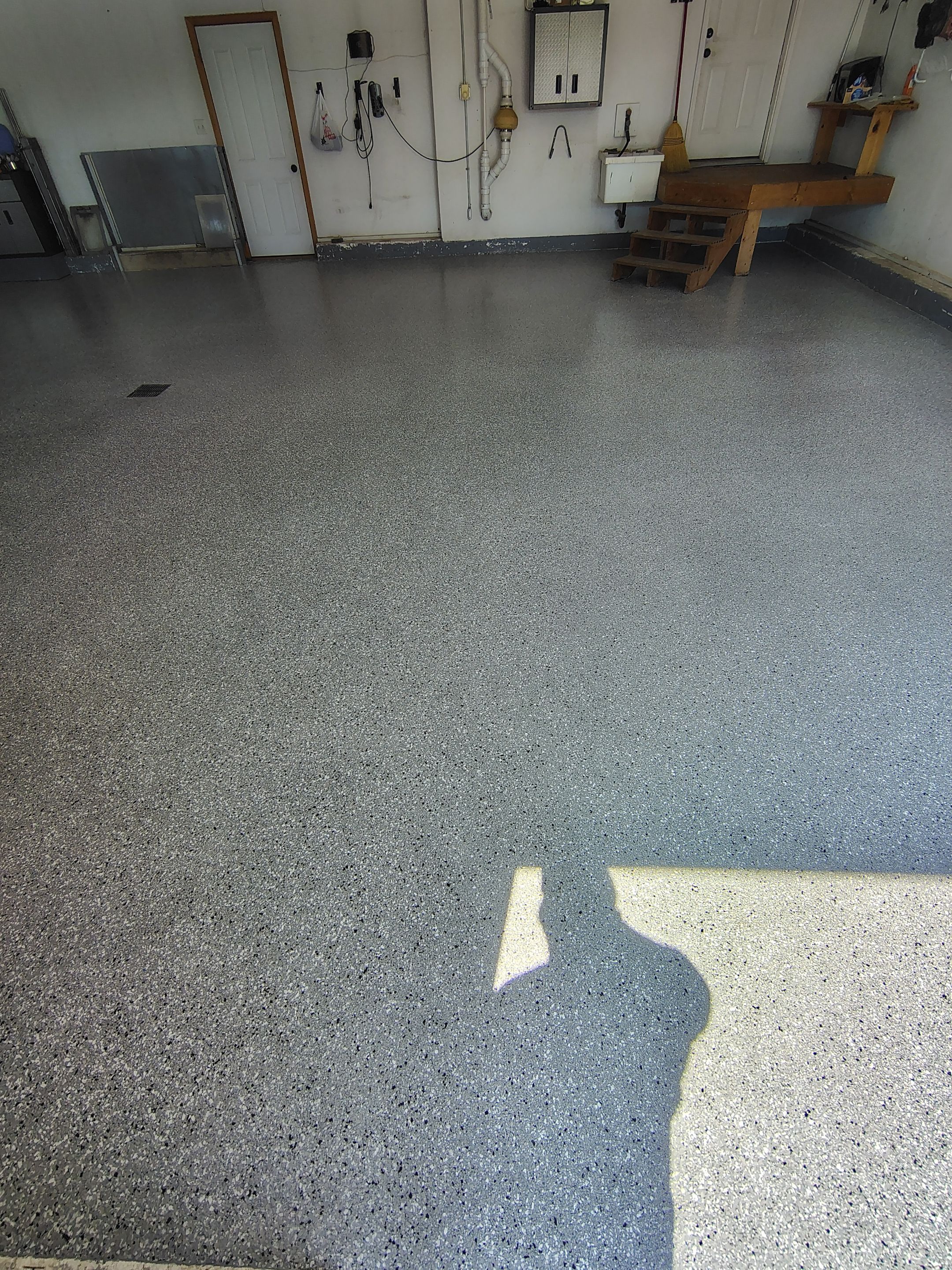 Feather Grey Garage Floor Coating Installation in Valley Springs by Select Painting, Coatings & Garage Cabinets