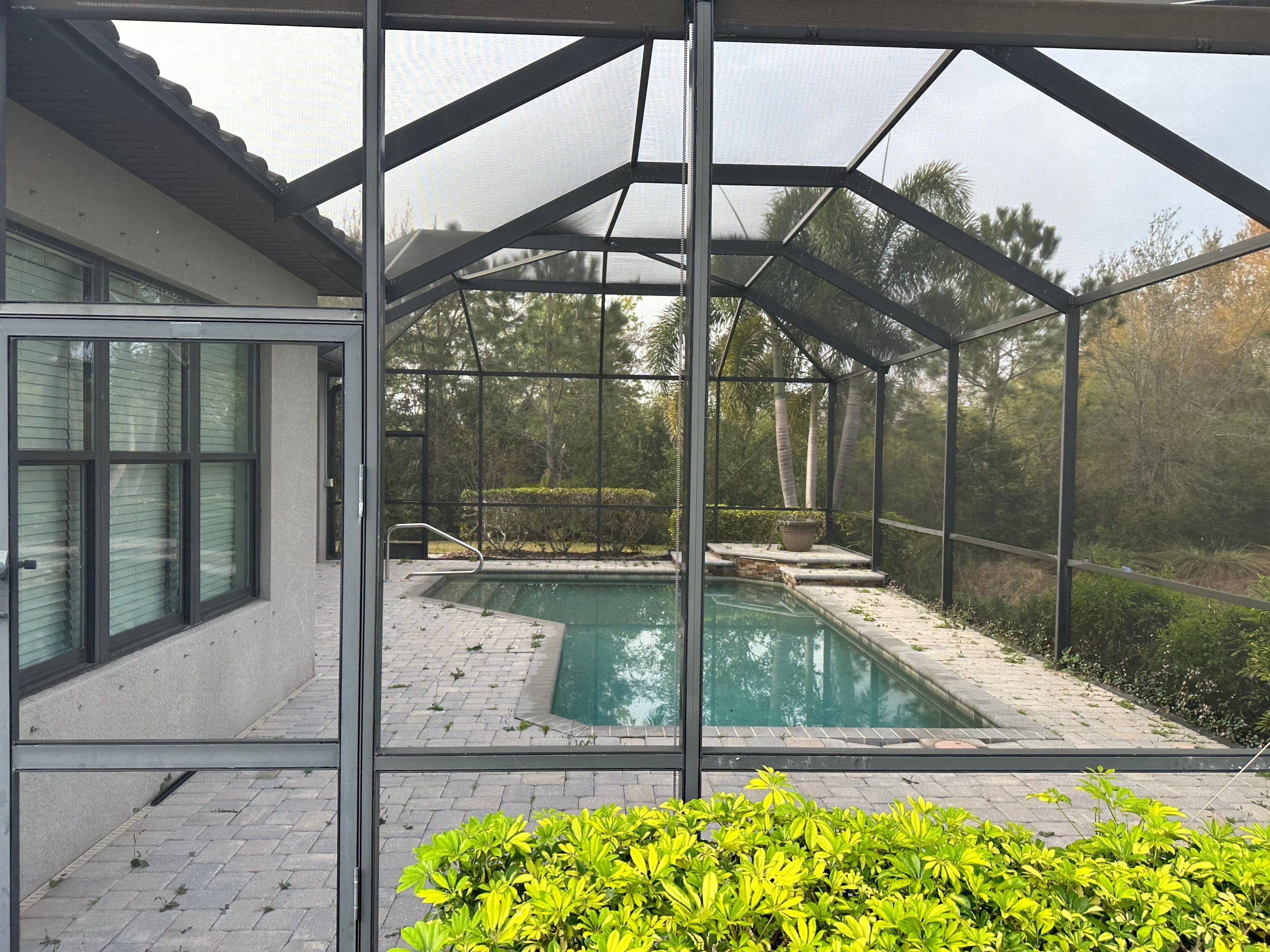 Concrete Tile Roof, Paver Pool Deck, Screen Enclosure & Driveway Cleaning in Artisan Lakes Esplanade, Palmetto, FL | Sunshine AquaWash by Sunshine AquaWash