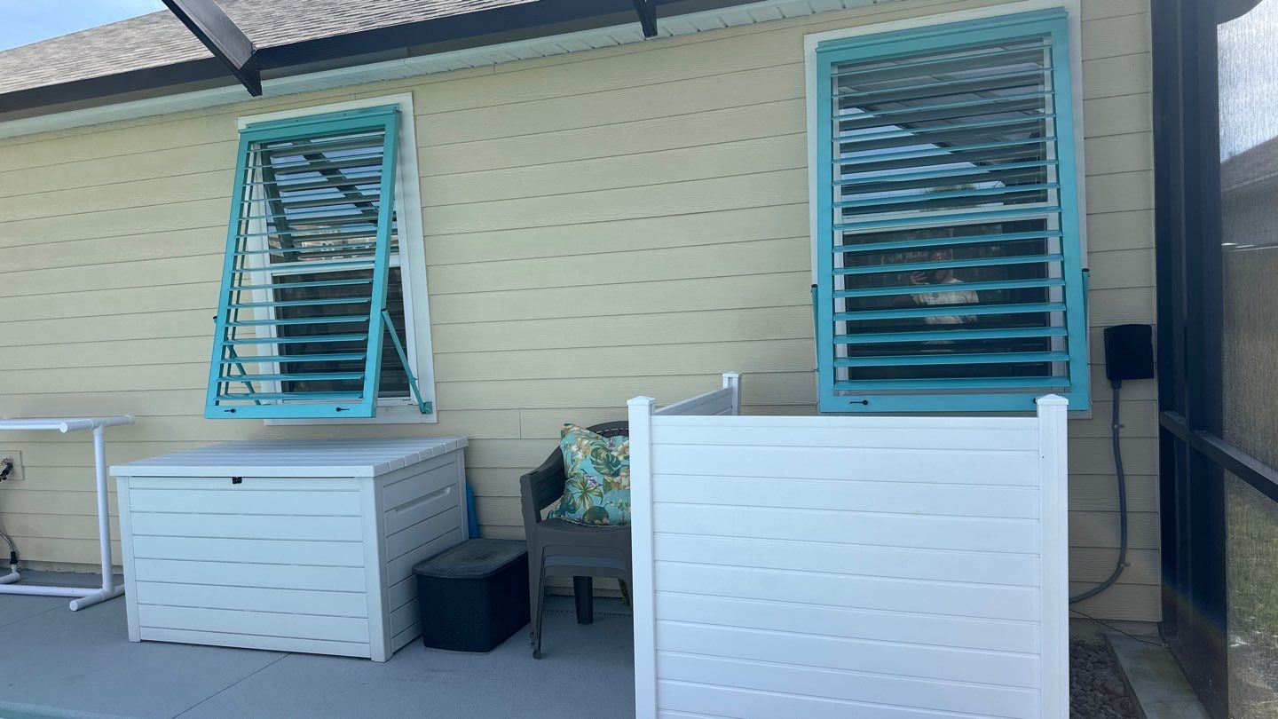Hurricane Rated Bahama Shutters in Light Green by Smart Guard Shutters