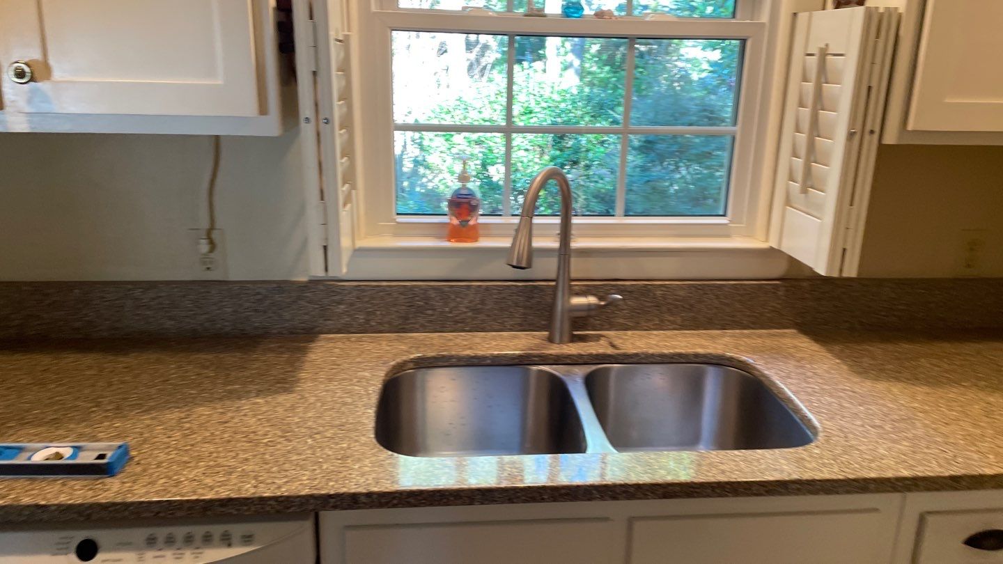 New Backsplash to Compliment the Countertops by Footprints Floors of Coastal Carolina