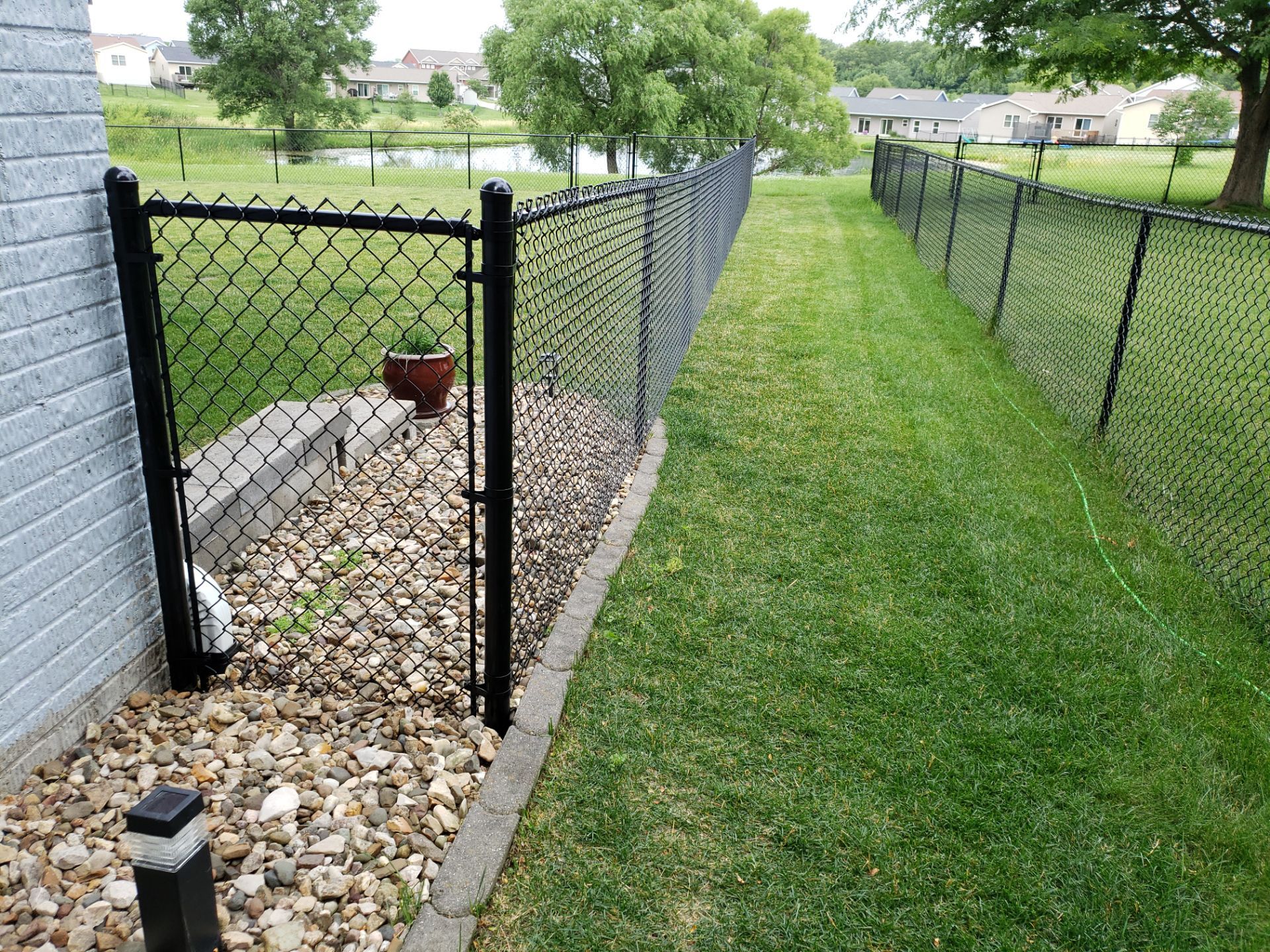 Black Vinyl Chain Link Perimeter Fence Installation in Waterloo by Perfect Picket Fence and Stain