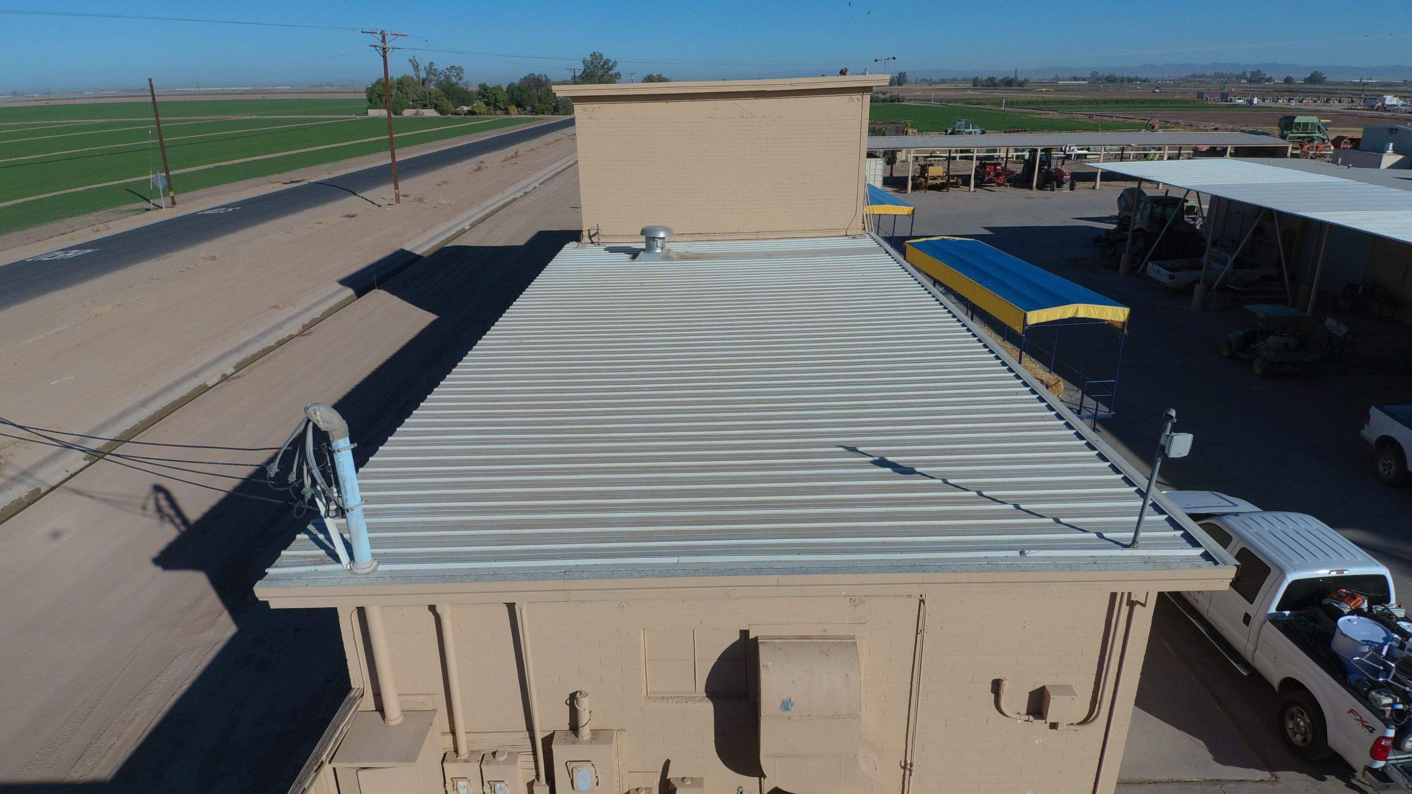 Metal roof restoration on commercial roof using Conklin Benchmark/PUMA XL fabric and coating by Straight Edge Roofing Inc