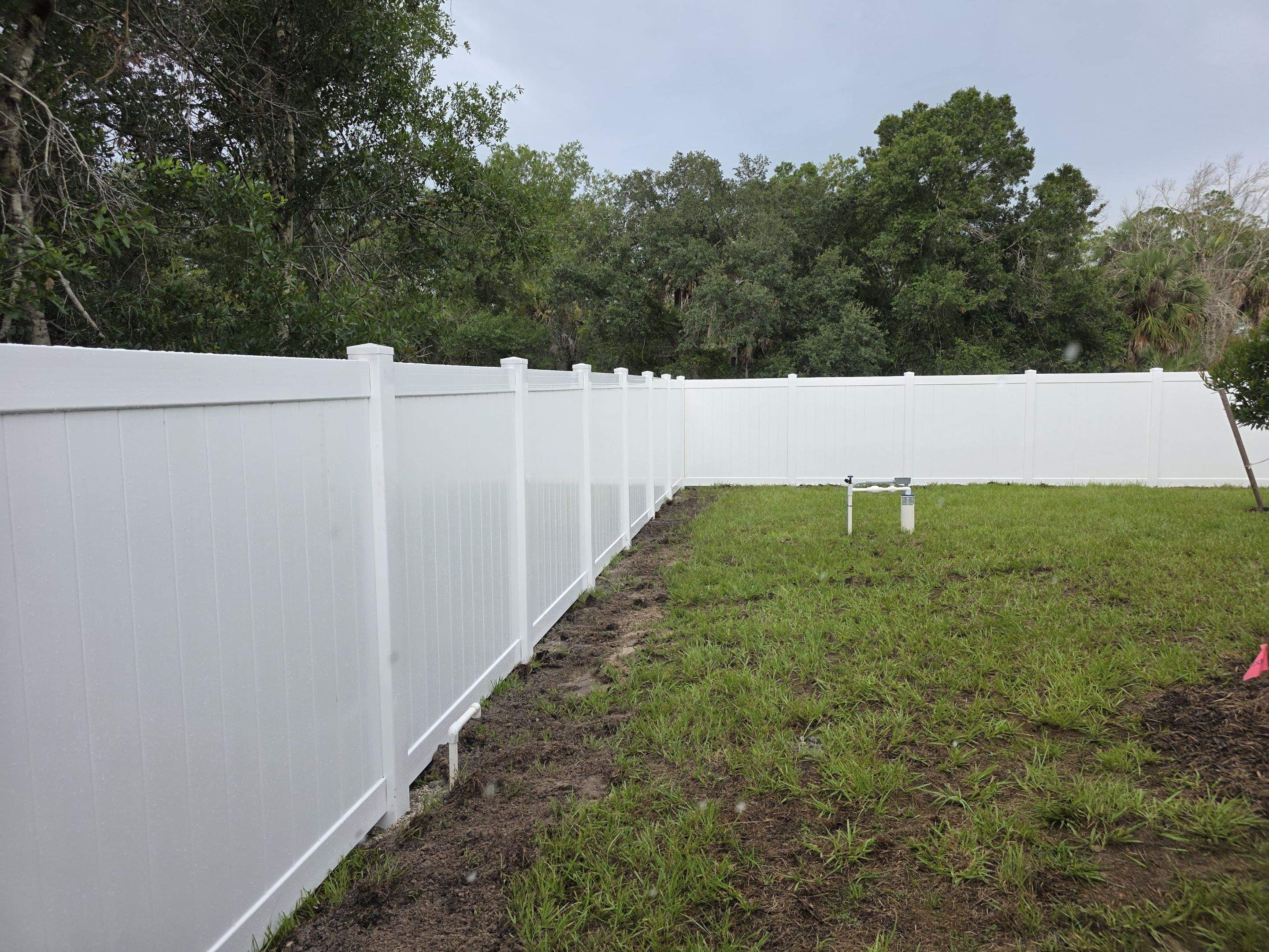 White Vinyl Privacy Fence with Gate Installation in North Port by True Fence LLC