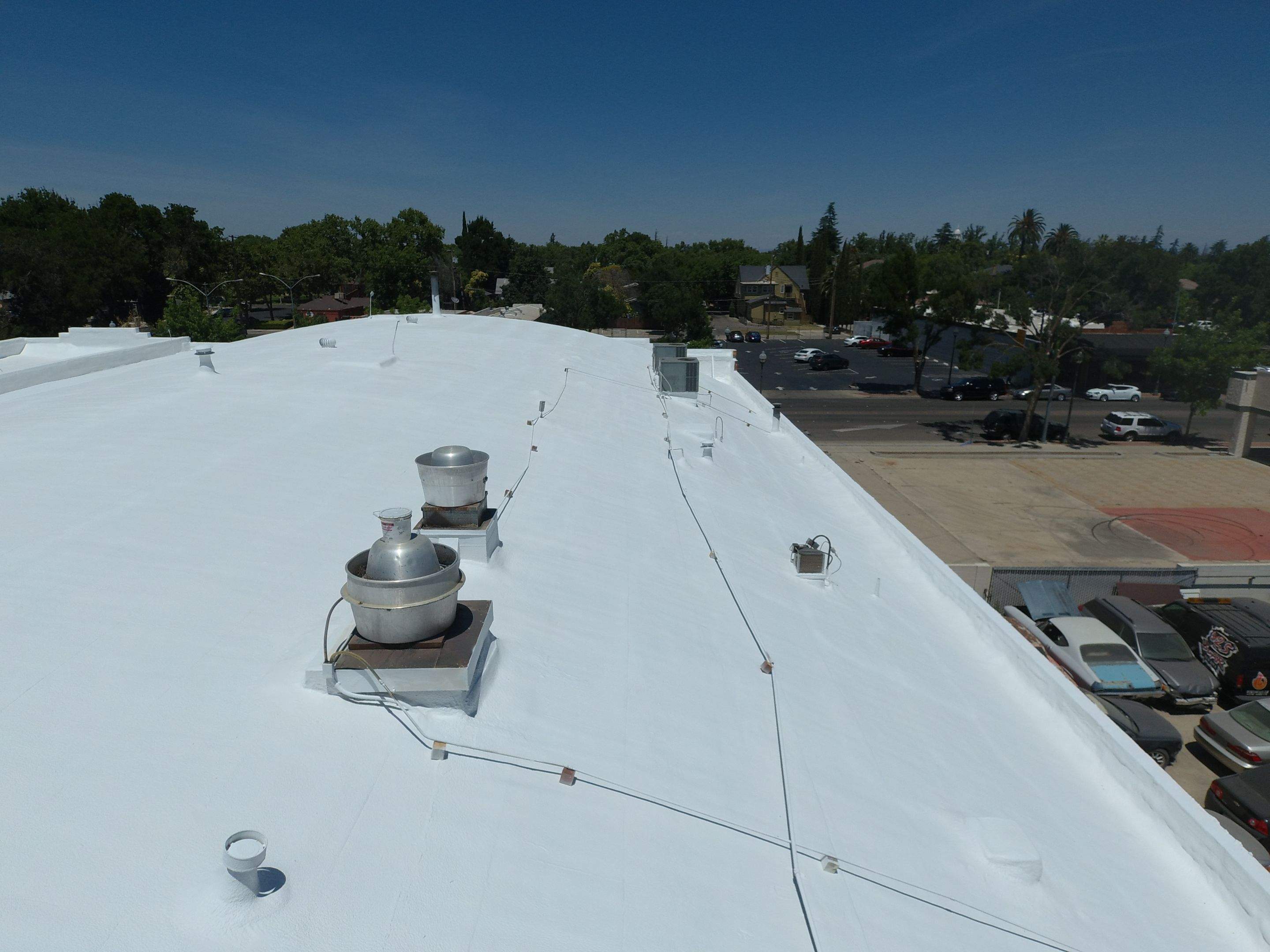 Spray foam and coatings using Conklin Benchmark/PUMA XL coatings and spray foam by Straight Edge Roofing Inc