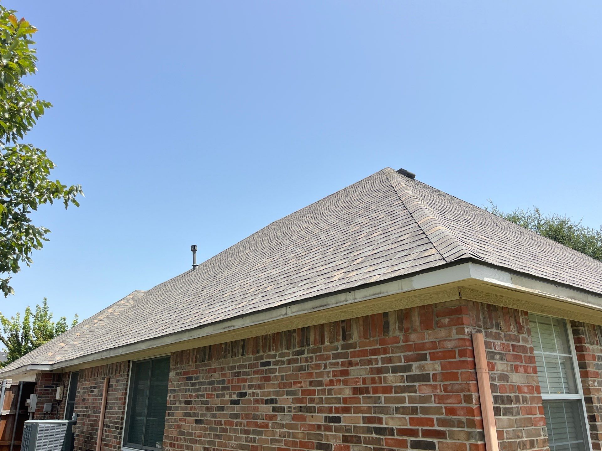 Red brick with IKO Cornerstone  by Tejas Roofworks + Restoration