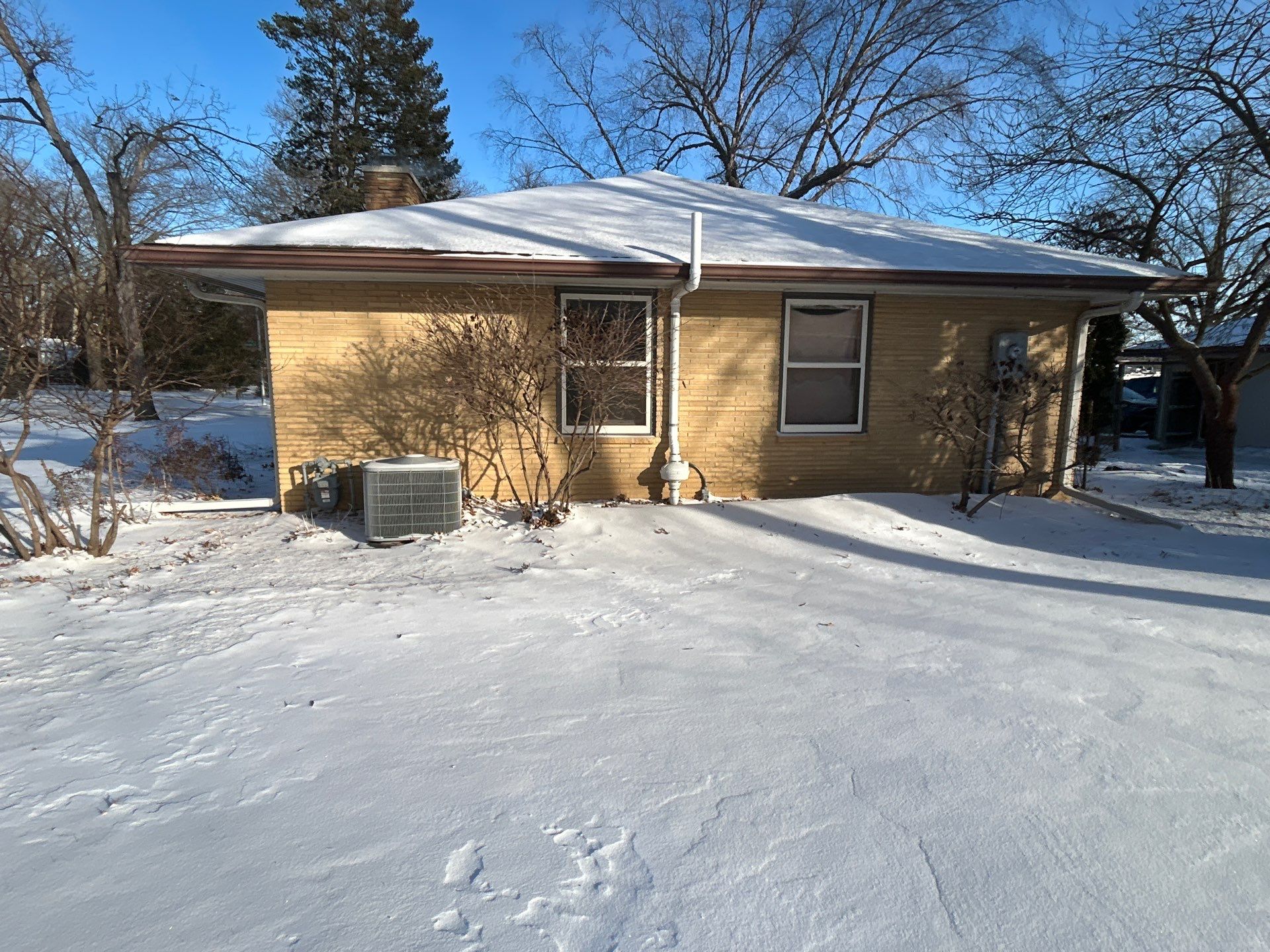 Black-Frame Pella Lifestyle Upgrade on a Partial Brick Home by United Windows and Siding LLC
