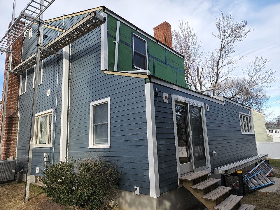 James Hardie siding, new metal roof and couple windows being installed. by UBrothers Construction