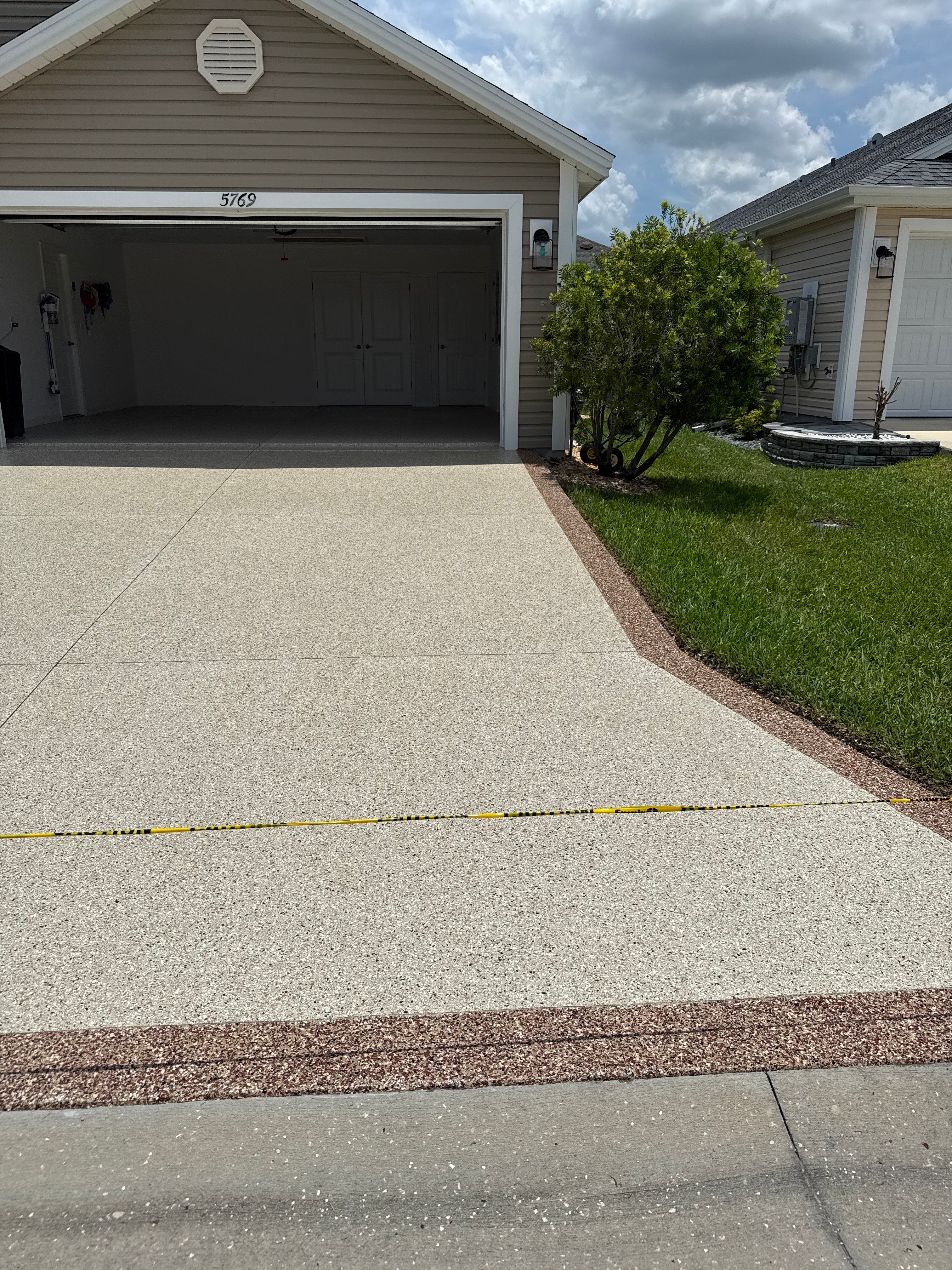 Driveway with Border by Innovative Concrete Coatings 