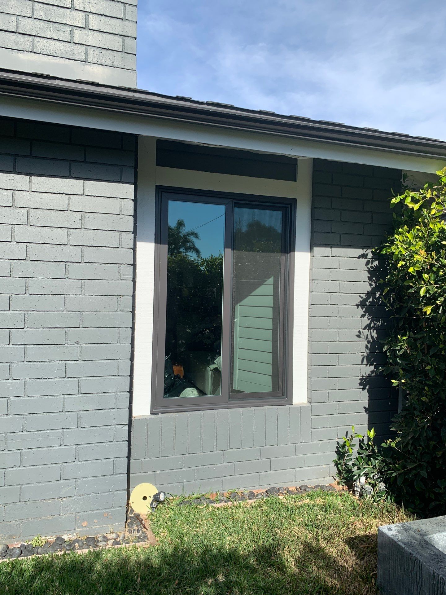 Window Installation using Milgard black vinyl windows by American Window Company