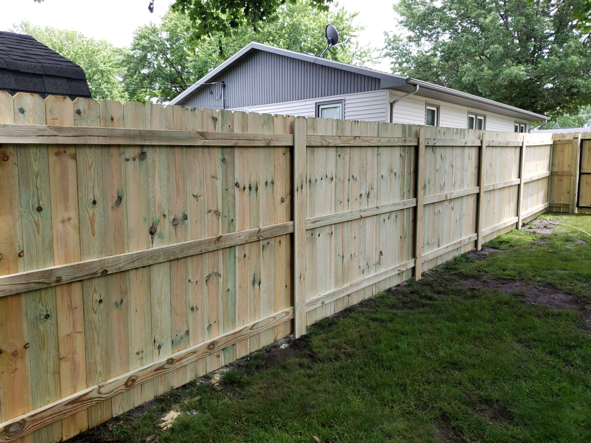Custom Wood Privacy Fence Installation for Charles City Backyard by Perfect Picket Fence and Stain