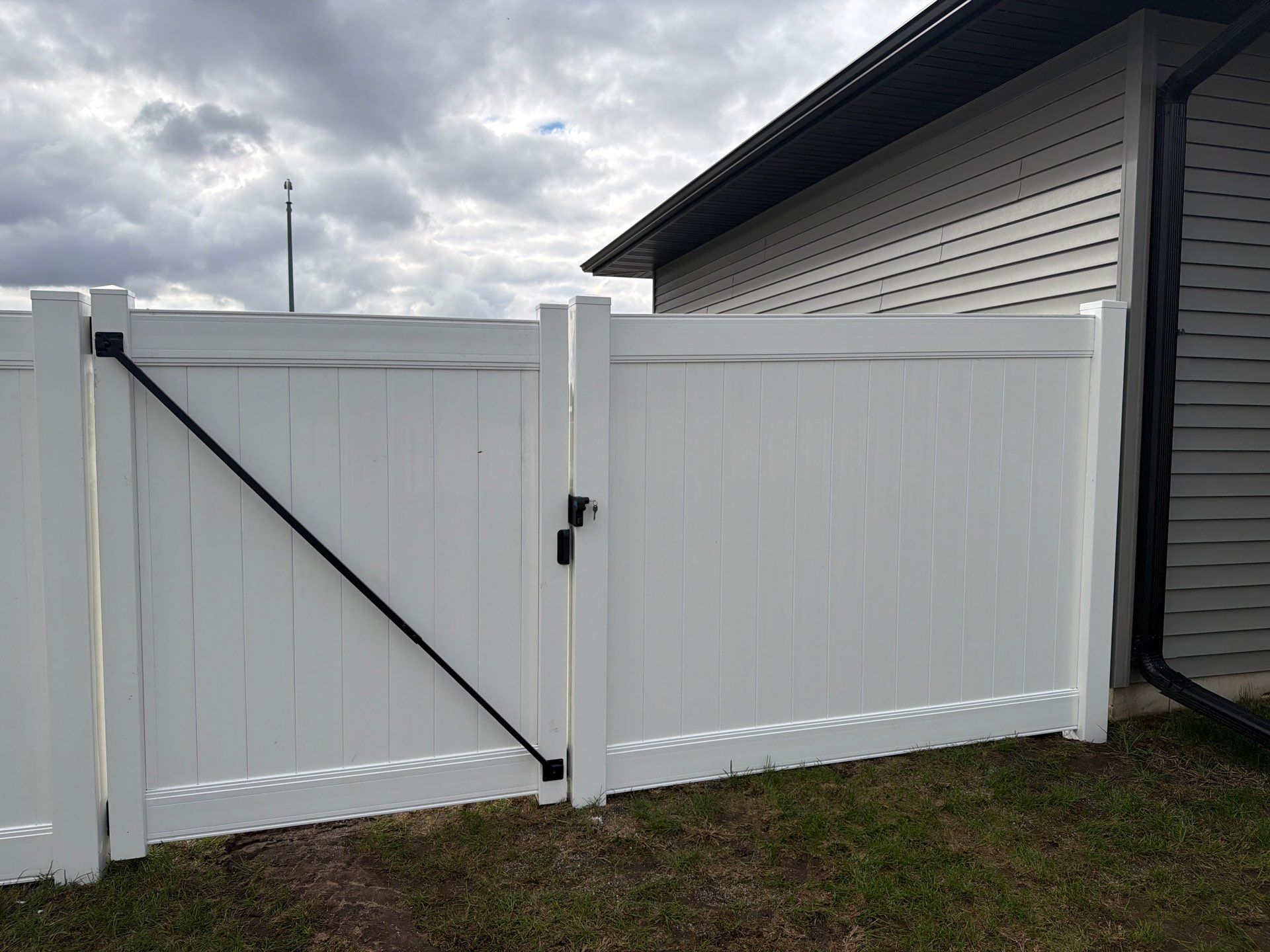Residential White Vinyl Privacy Fence Installation in Janesville by Perfect Picket Fence and Stain