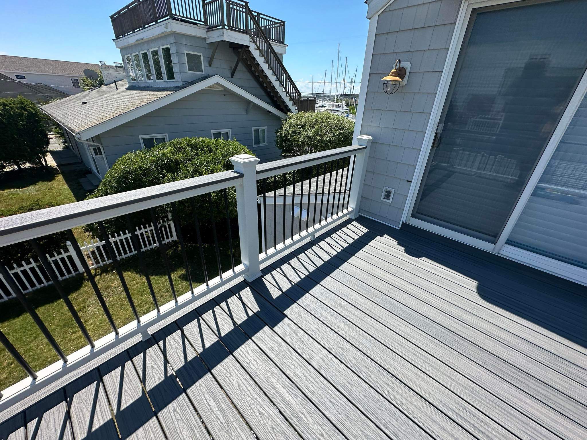 Deck Replacement Trex Lineage Island mist decking and Matching cocktail rail, Wrapped posts and beam.  by DiGiorgi Roofing and Siding Inc