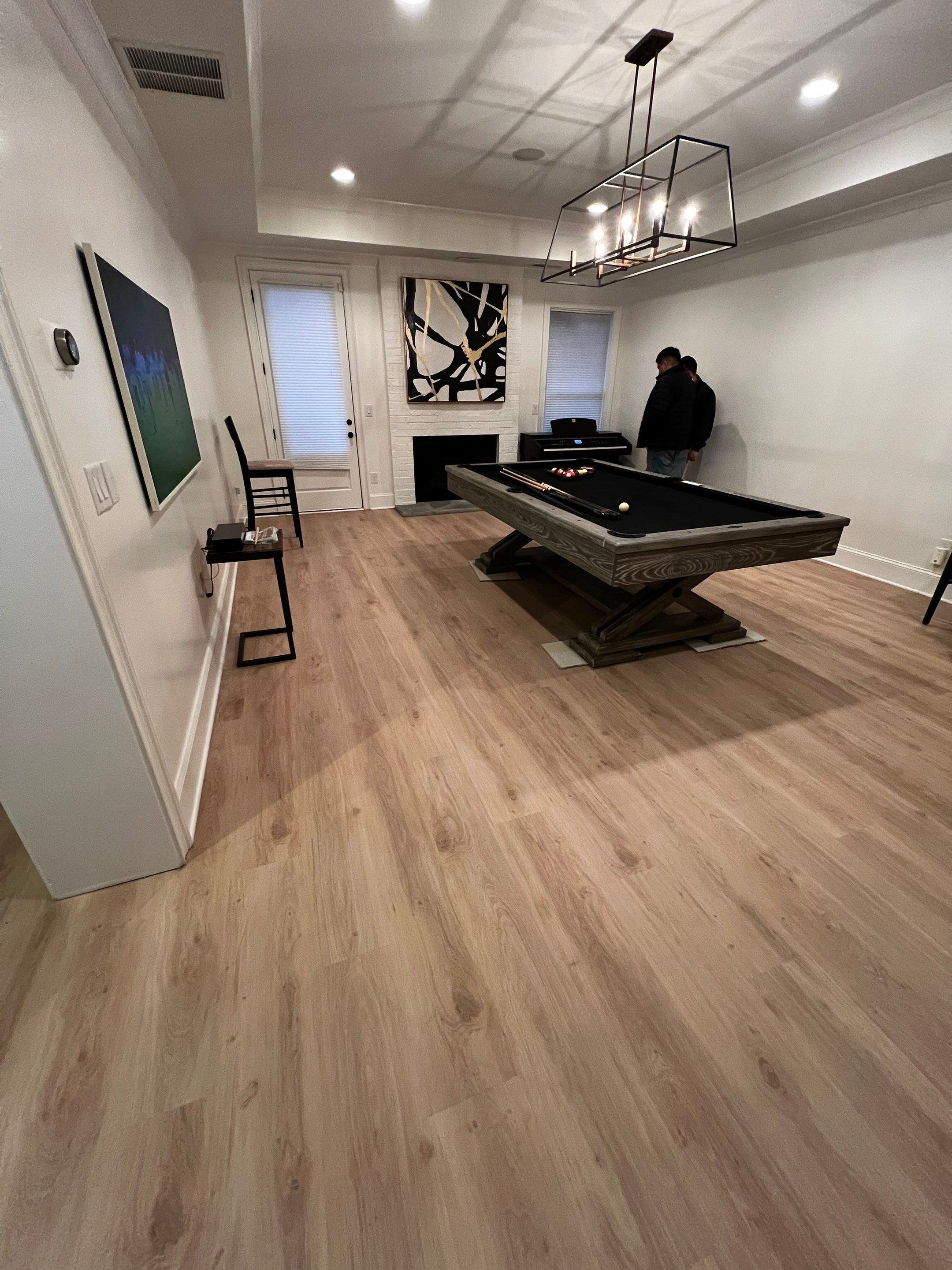 Atlanta Basement Refinishing with Wood Laminate Flooring and Interior Painting by Swift Home Renovations