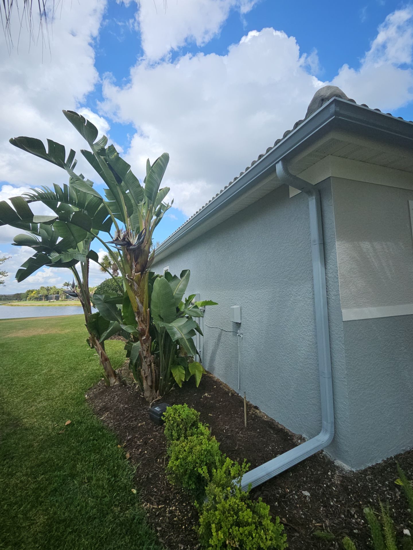6-inch K-style Seamless Gutters and Splash Guard in Grey Color in Naples FL by Gutter Professors