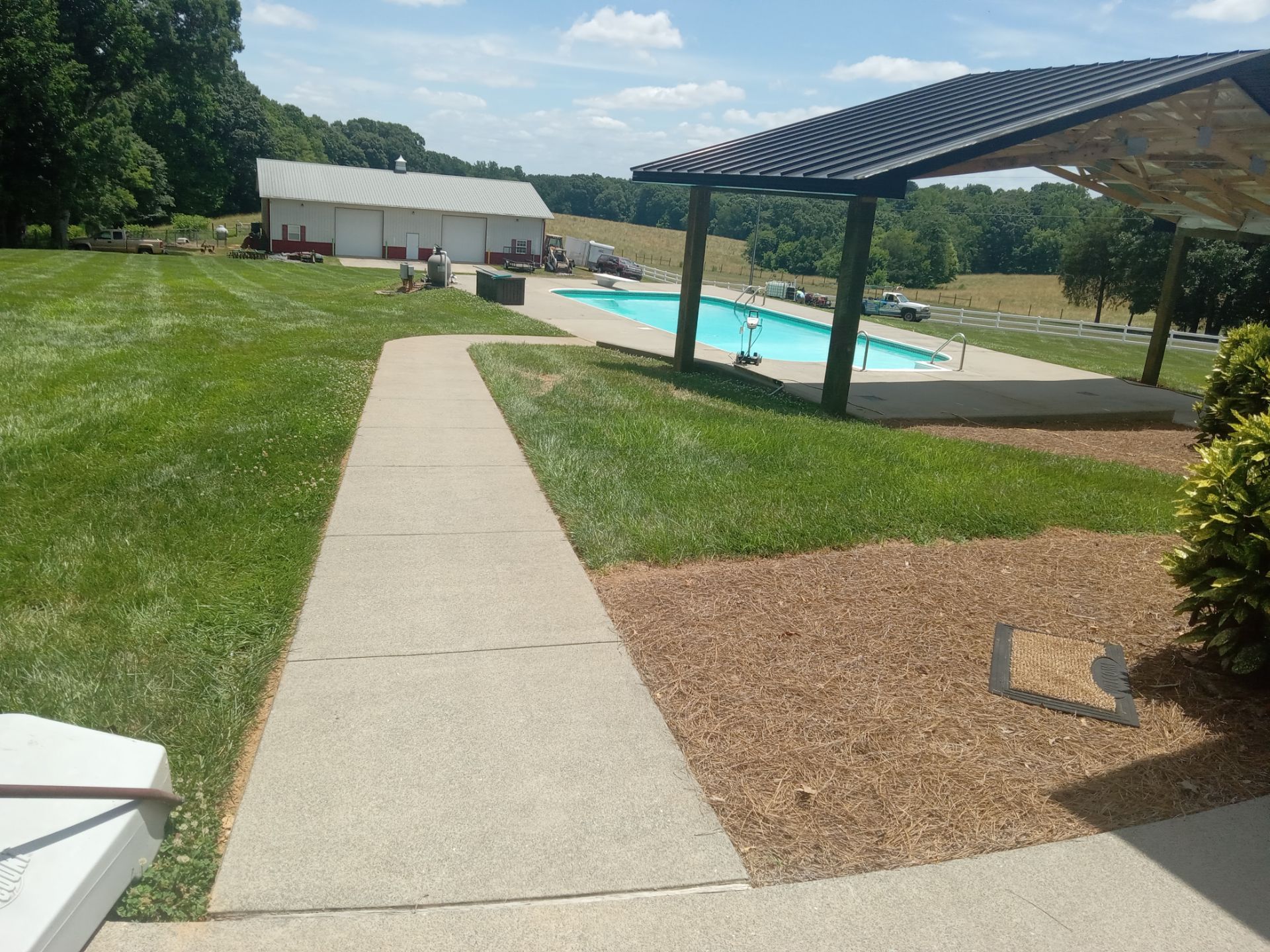 pressure washing concrete walkways and pool deck areas to remove dirt buildup and stains for cleaner surfaces