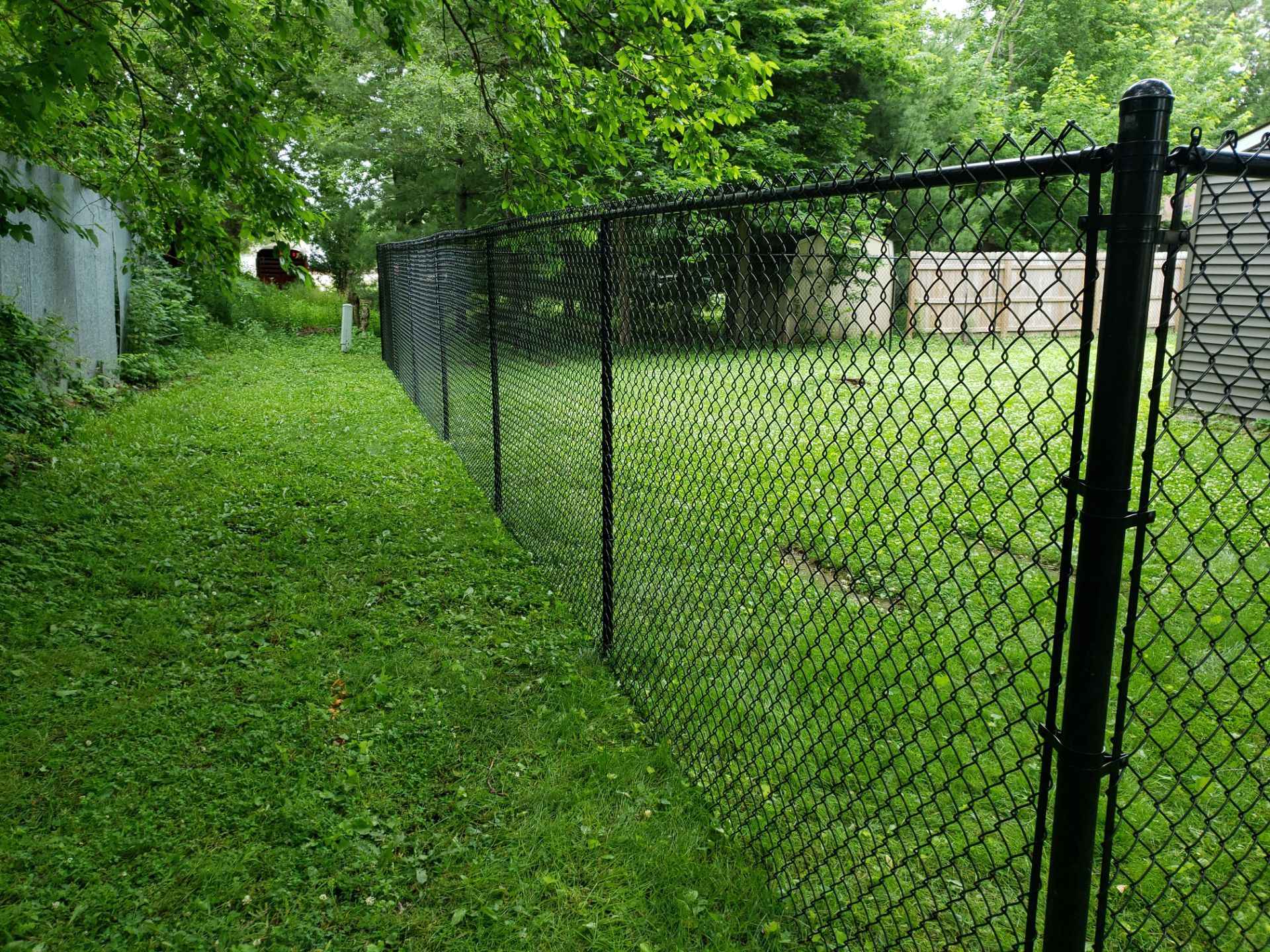 Black Vinyl Chain Link Fence Installation in Charles City by Perfect Picket Fence and Stain