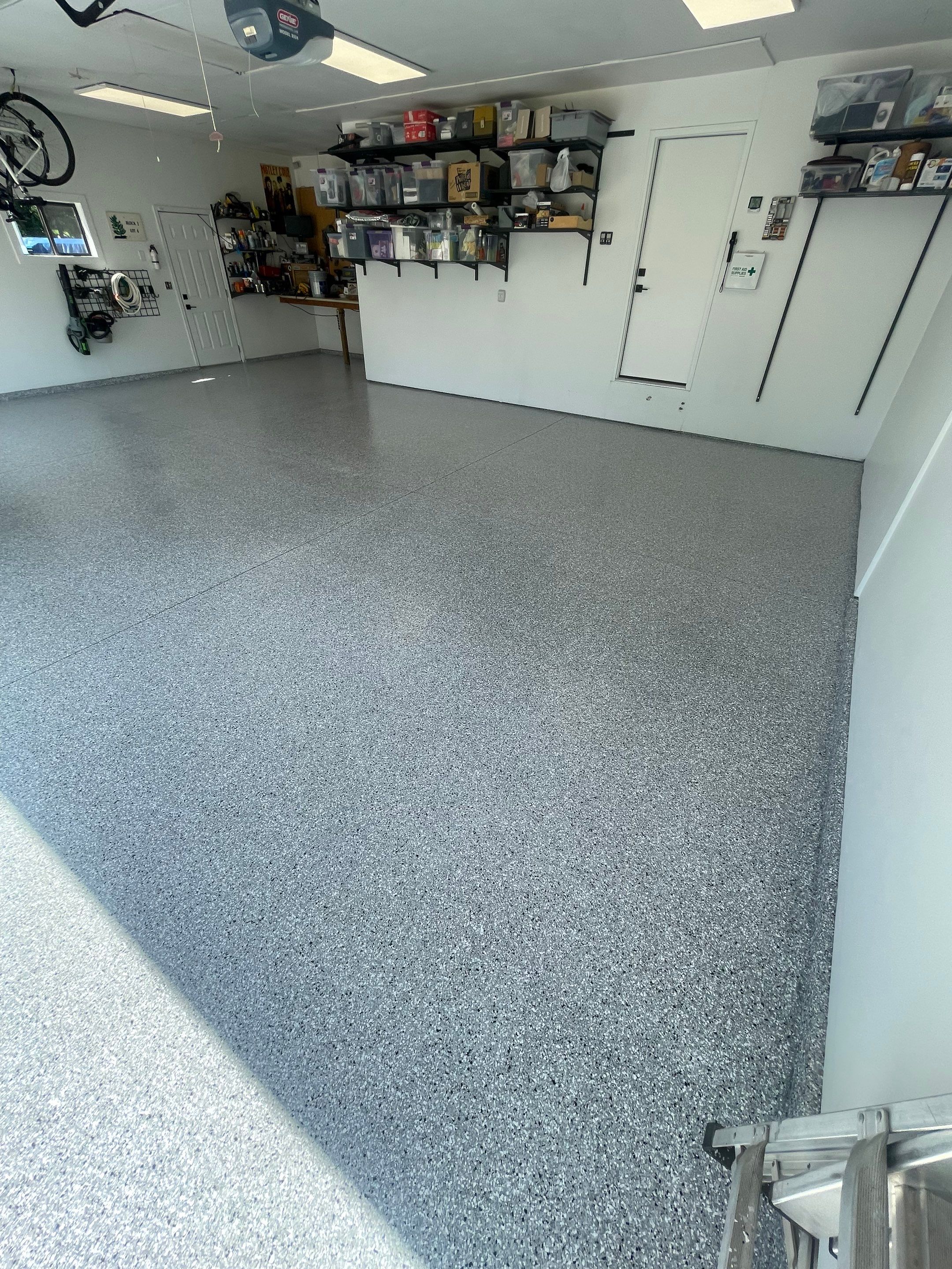 Feather Grey Garage Floor Coating Installation in Sioux Falls by Select Painting, Coatings & Garage Cabinets