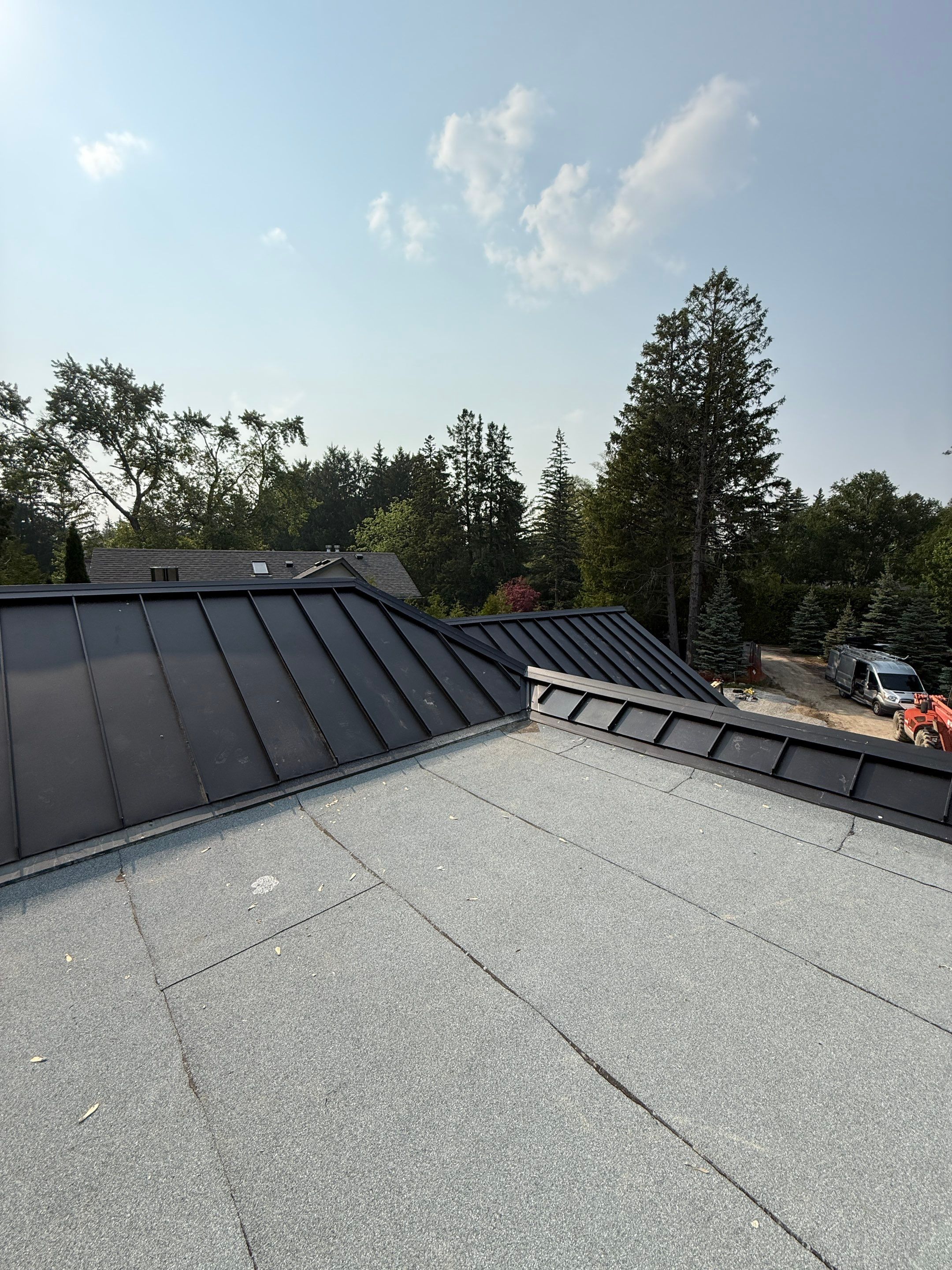 Custom Home Jet Black 24 GA Standing Seam Roof  by Jay Carter Roofing & Sheet Metal