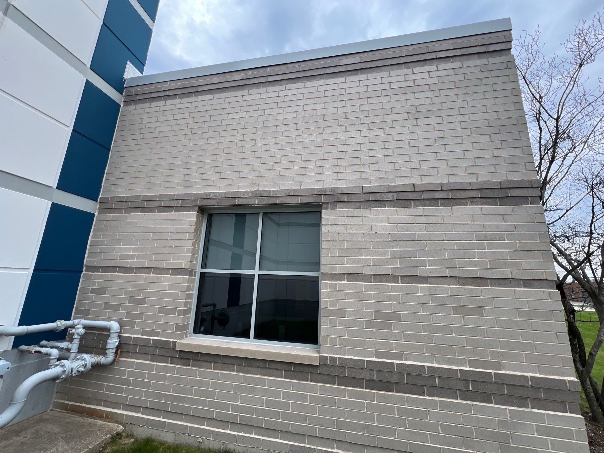 Commercial Facade cleaning using Algaecide, soft wash soap by Northern Power Washing LLC.