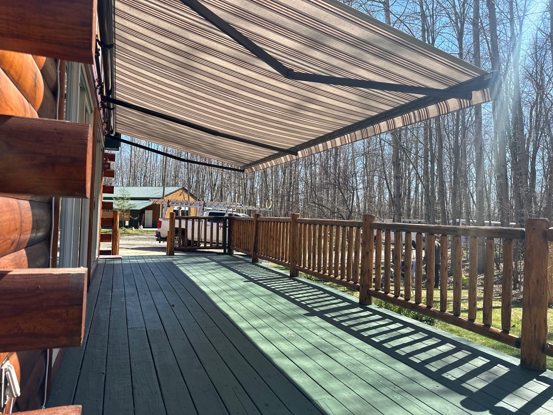 Retractable Awning Installation and Exterior Maintenance in Houghton Lake by Rainbow Seamless Systems
