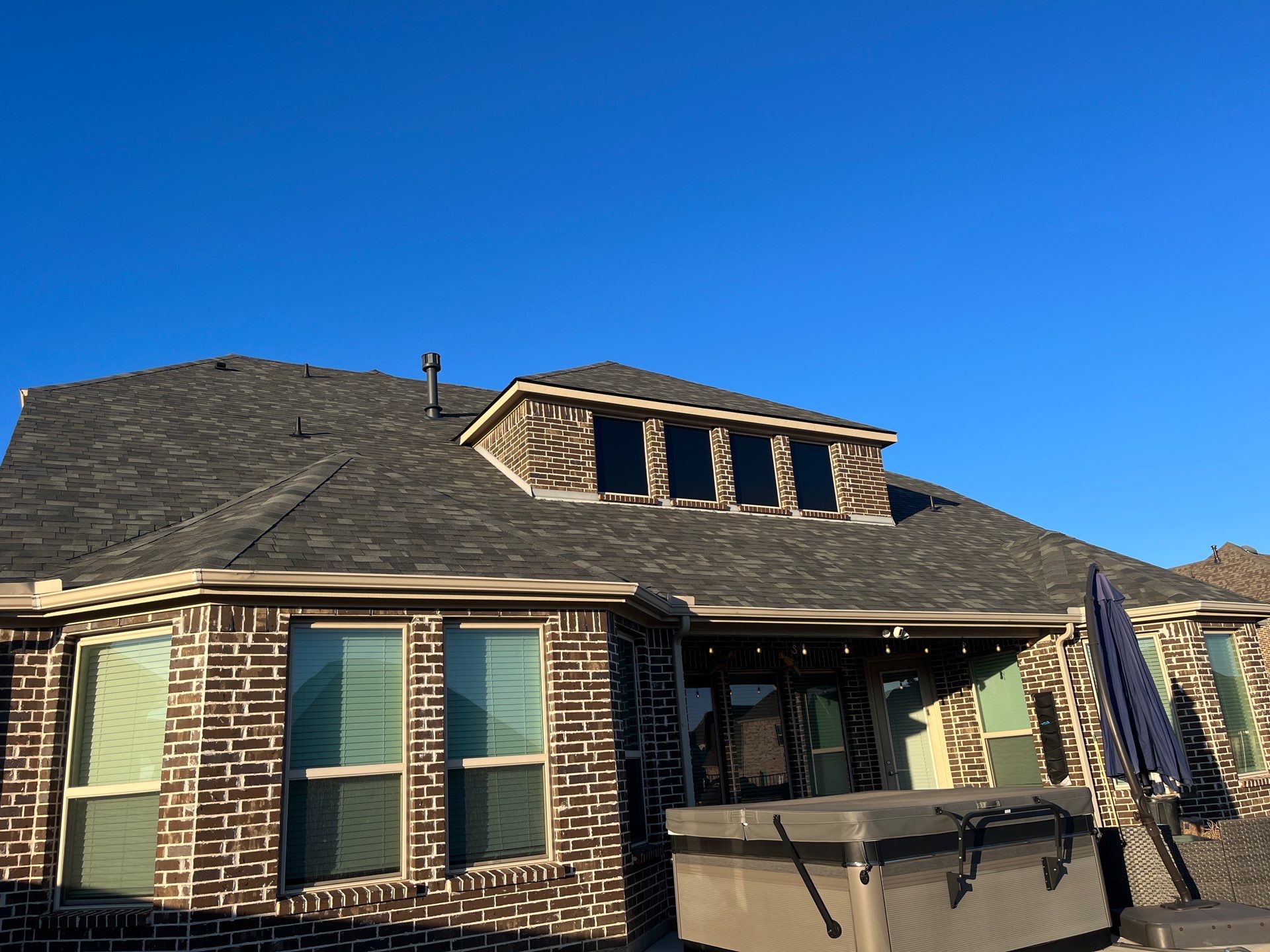 Red Brick with Malarkey Storm Grey by Tejas Roofworks + Restoration