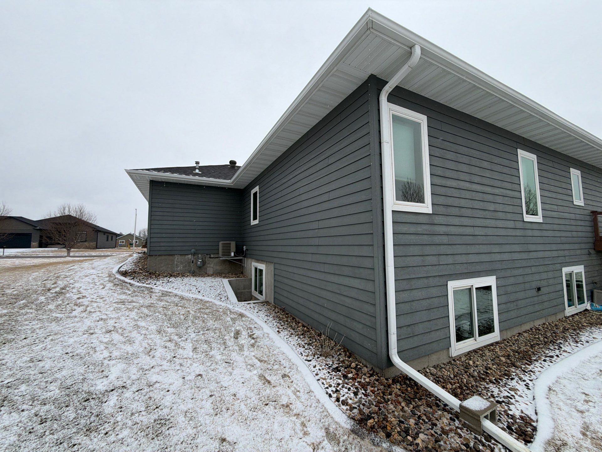 Madison Exterior Remodel with Dark Gray Siding and Stone Accents by Select Painting, Coatings & Garage Cabinets