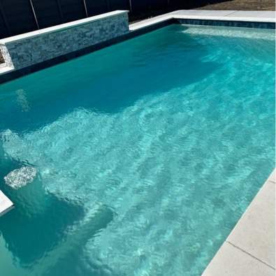 Geometric Pool with Raised Spa and Tanning Ledge by Pinnacle Pools and Spas - DFW