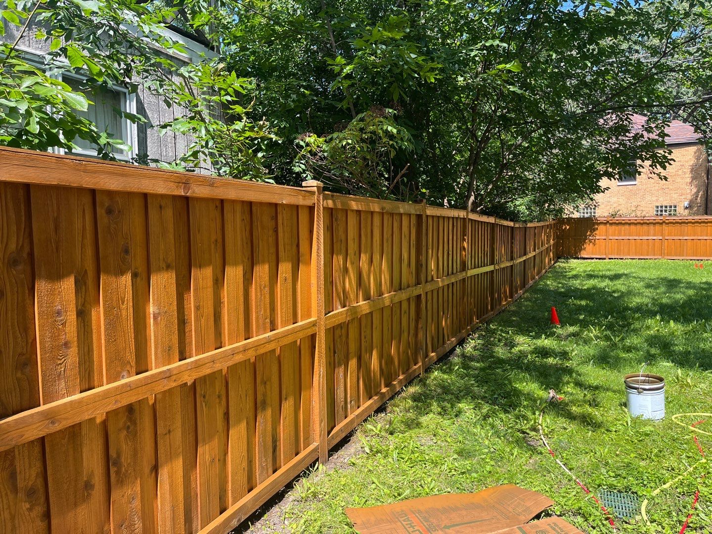 Wood fence cleaning and sealing by Northern Power Washing LLC.